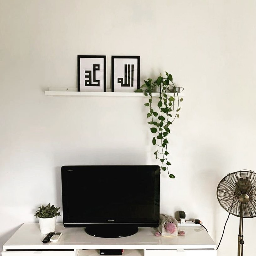 29. a Trio Of White Geometric Shelves with Cylindrical Vases and Greenery