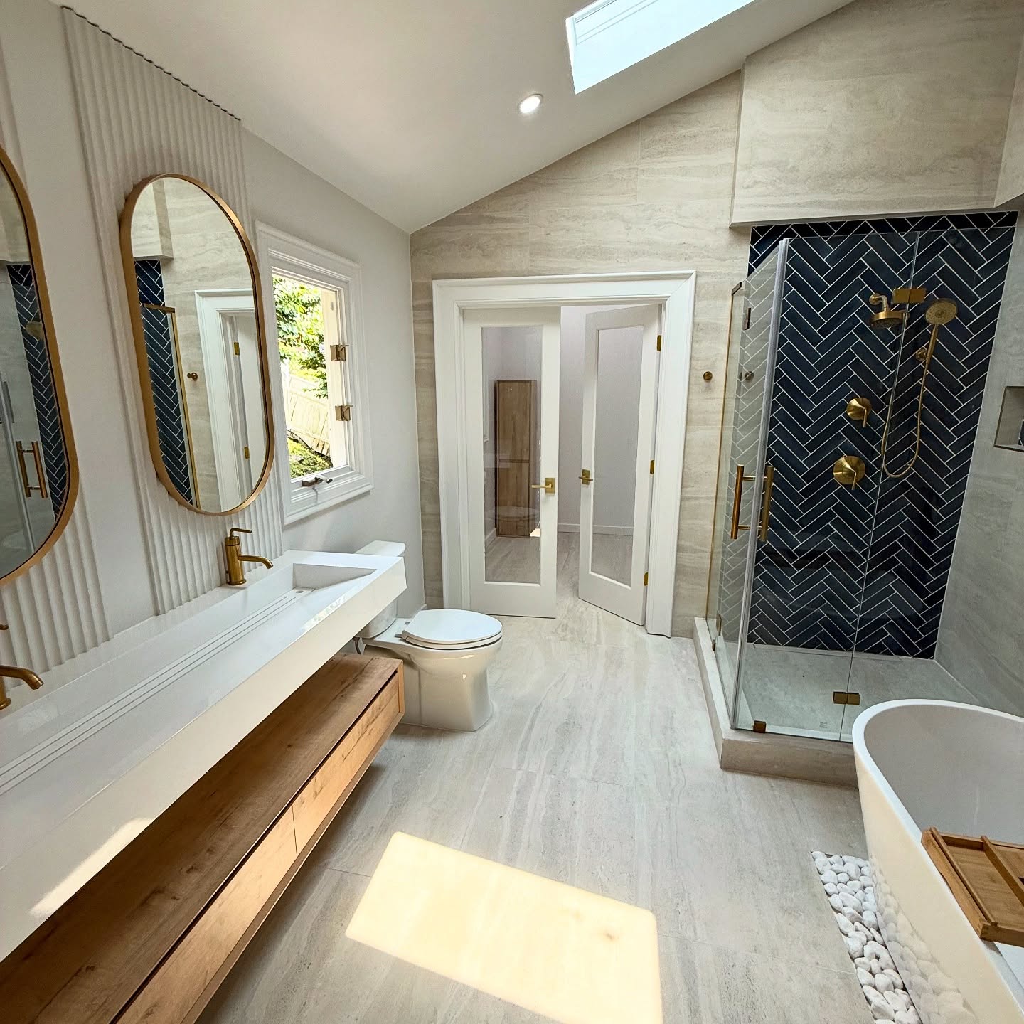 32. Cascading Waterfall Tiles and Amber Glow Lighting In a Compact Walk-in Shower
