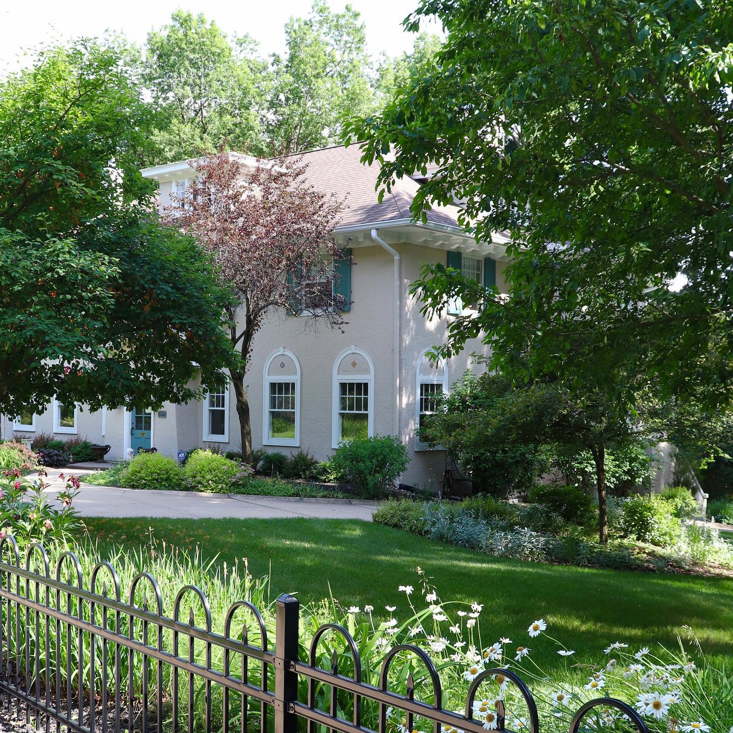 6. Low Fence with Climbing Roses and Solar Lanterns In a Cozy Cottage Setting