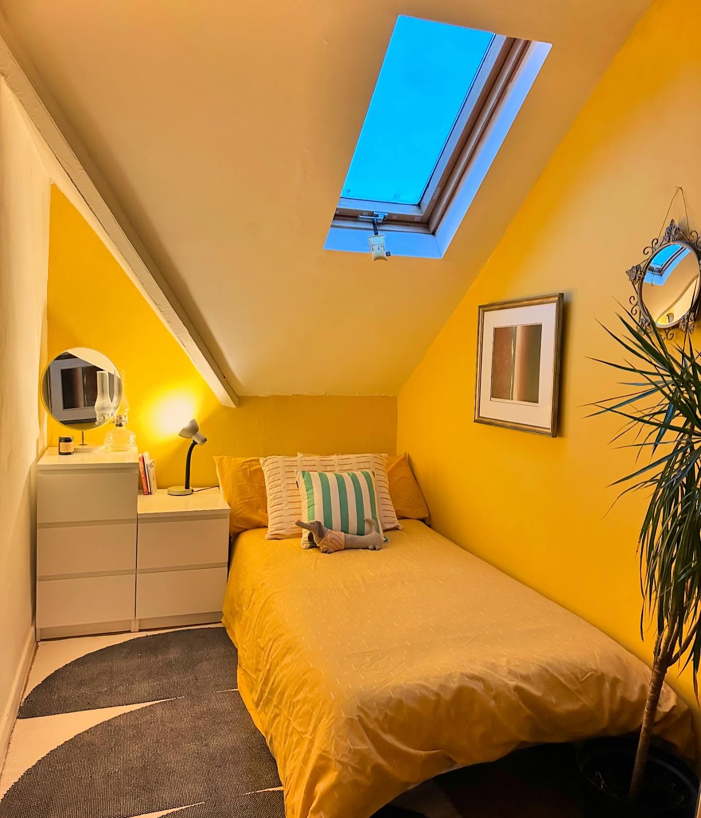 9. Cozy Nook with a Sunlit Reading Bench and Exposed Beam Ceiling