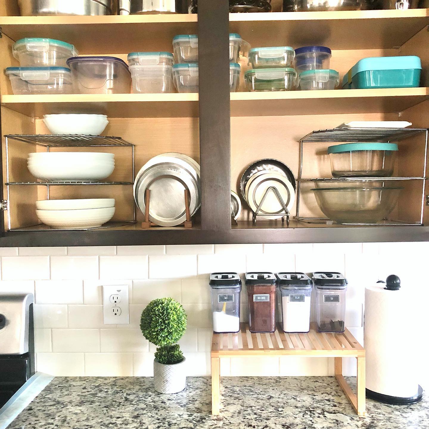 1. Glass-fronted Charm: Transparent Doors Reveal a Spice Rack and Utensil Harmony