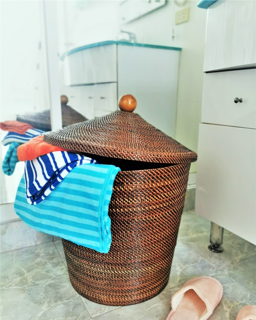 22. the Interwoven Wicker and Chrome Laundry Basket with Potted Plant Accent