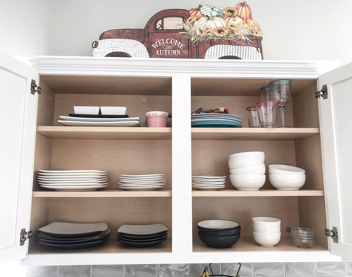 27. Sleek Pull-out Drawers with Geometric Spice Jars Under a Butcher Block Countertop