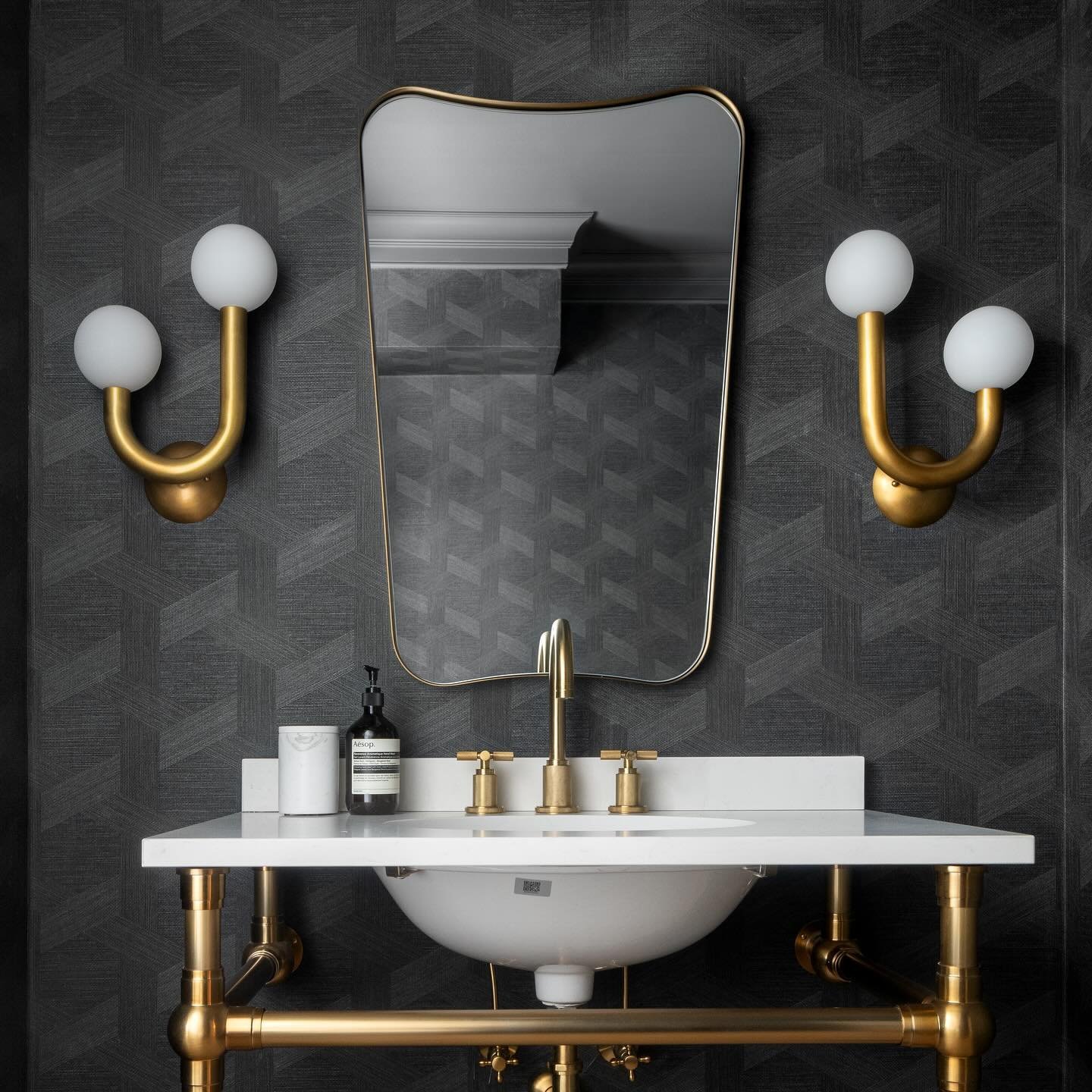 18. Frosted Glass Vanity and Geometric Mirror Fusion In a Softly Lit Powder Room