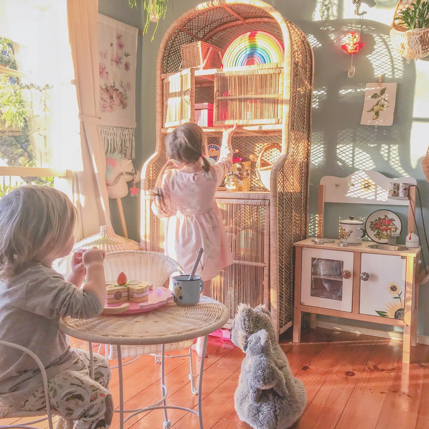 13. Kids' Play Corner with Vibrant Rainbow Wall and Suspended Toy Storage