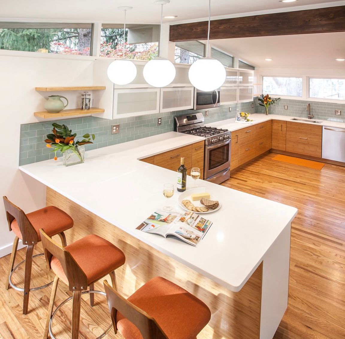 29. Mid Century Maple Cabinets with Geometric Tile Backsplash and Atomic Era Clock