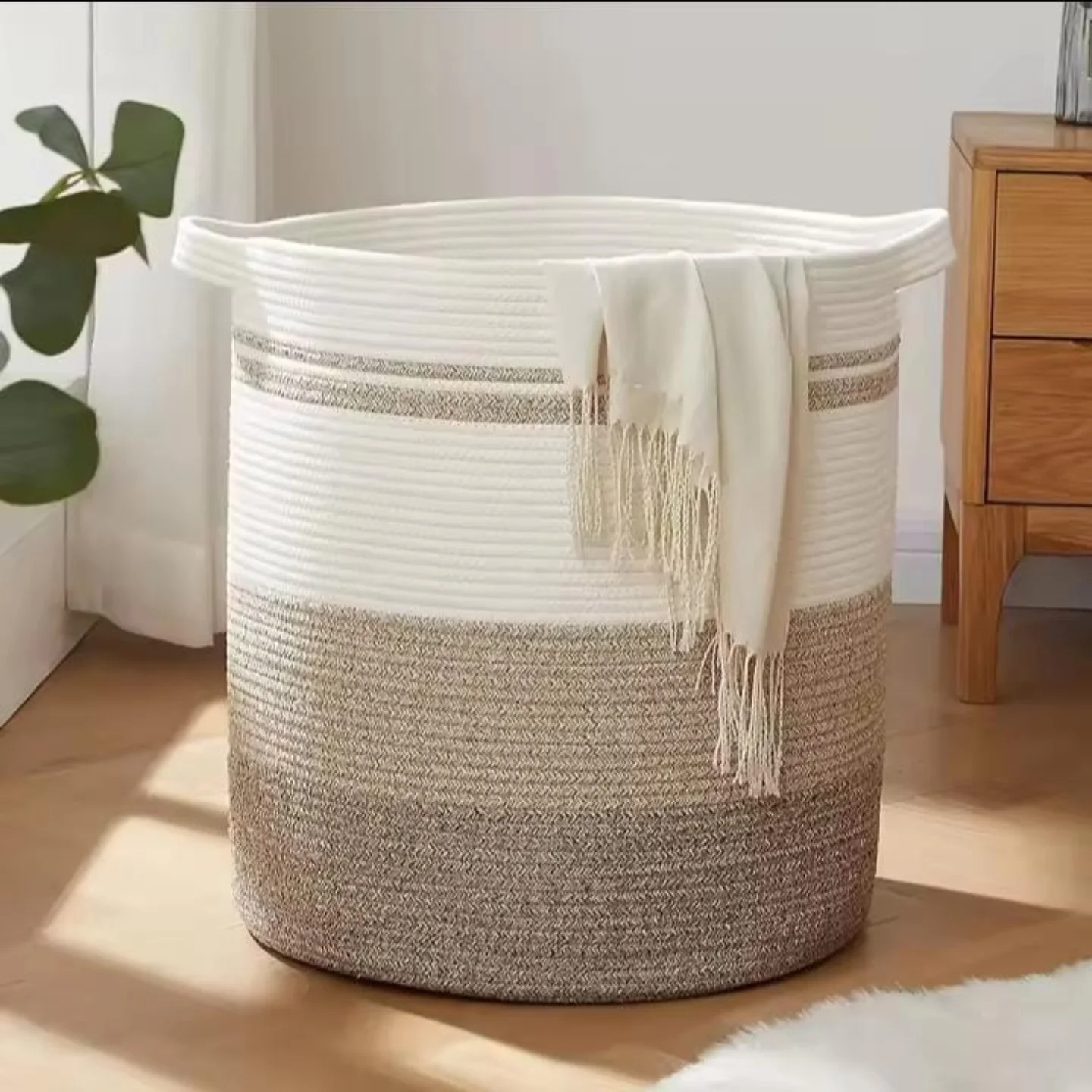 11. Sleek White Hamper with Geometric Cutouts on a Glossy Black and White Tiled Floor