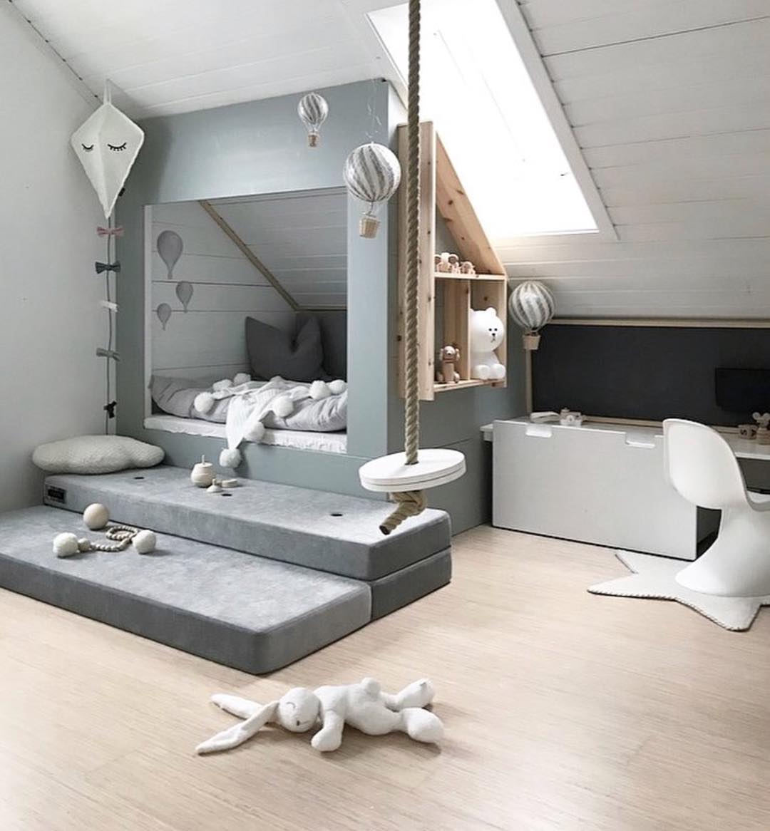 9. Whimsical Aviator-themed Playroom with Suspended Toy Plane and Vintage Trunk