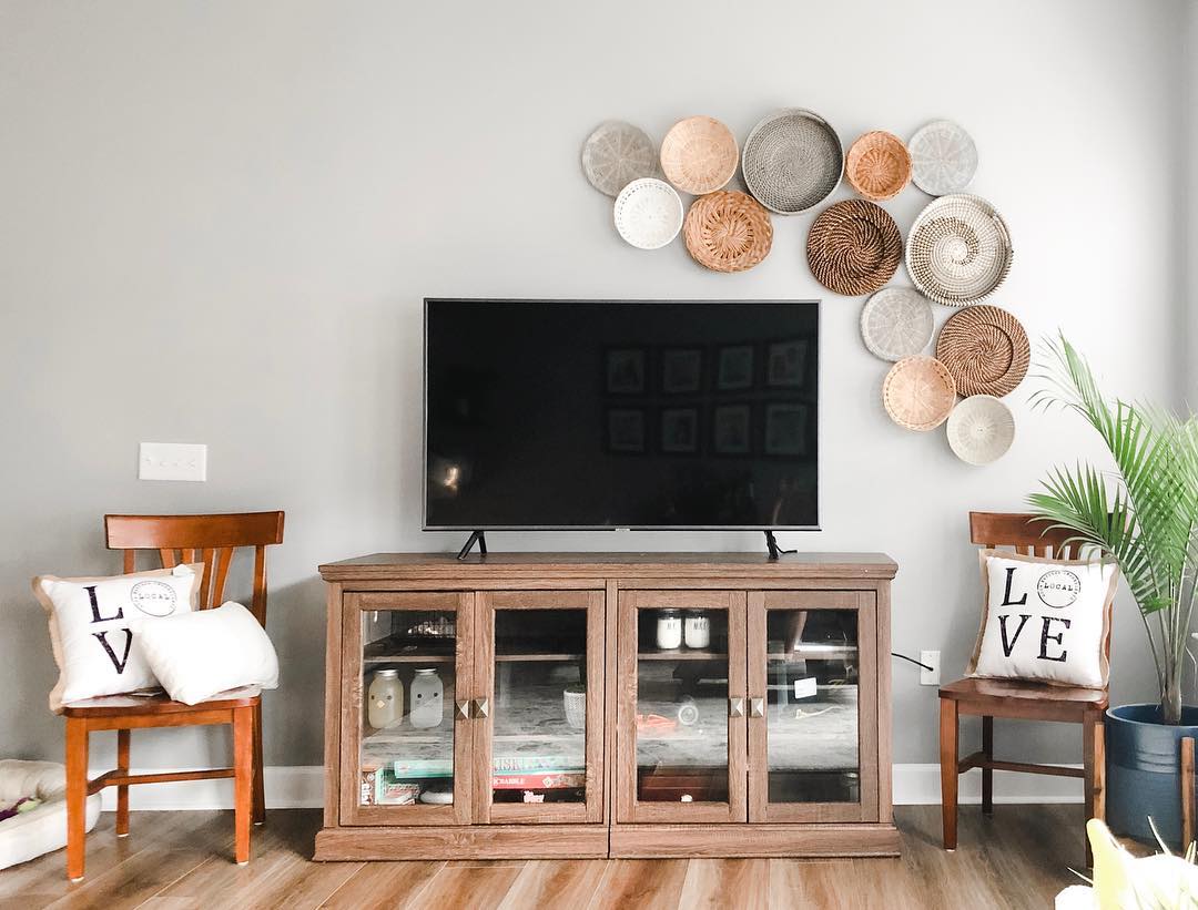 15. Suspended Wooden Shelf with Potted Plant and Geometric Art Above Flatscreen Tv