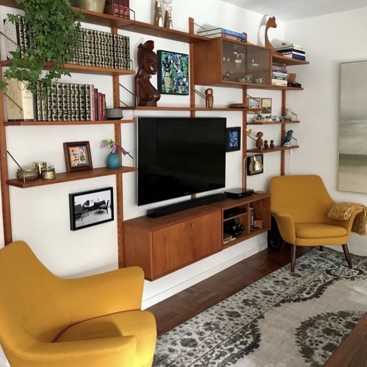 12. Cascading Greenery and Geometric Shelves Frame Your Tv Experience