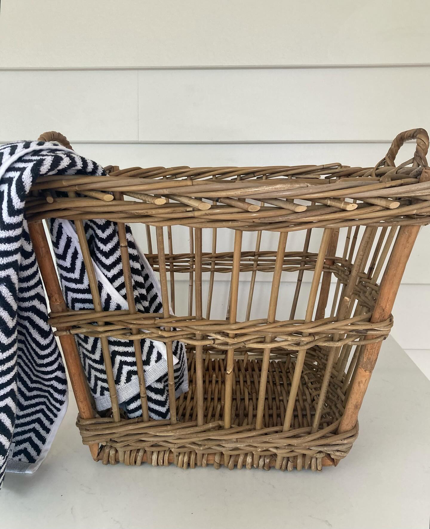 21. Cobalt Blue Wicker Basket with White Towel Draped Over Edge