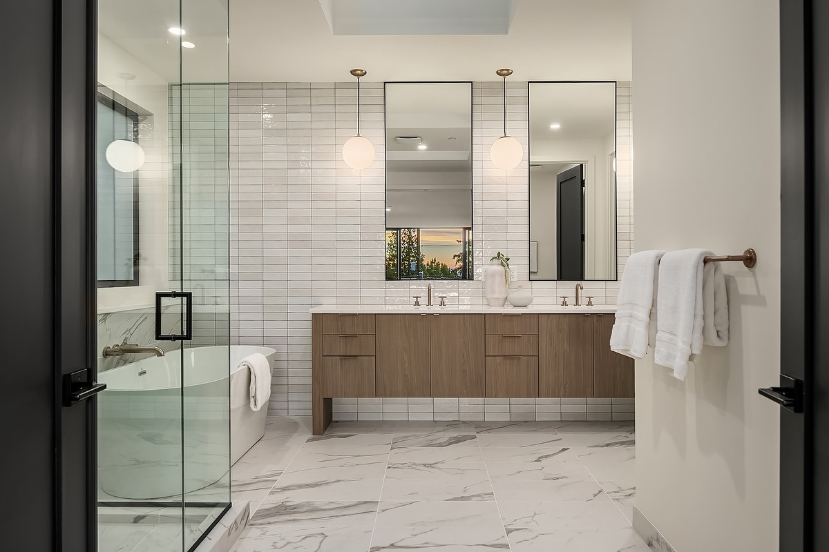 21. Cascading Waterfall Tiles and Floating Wood Vanity In a Zen Retreat