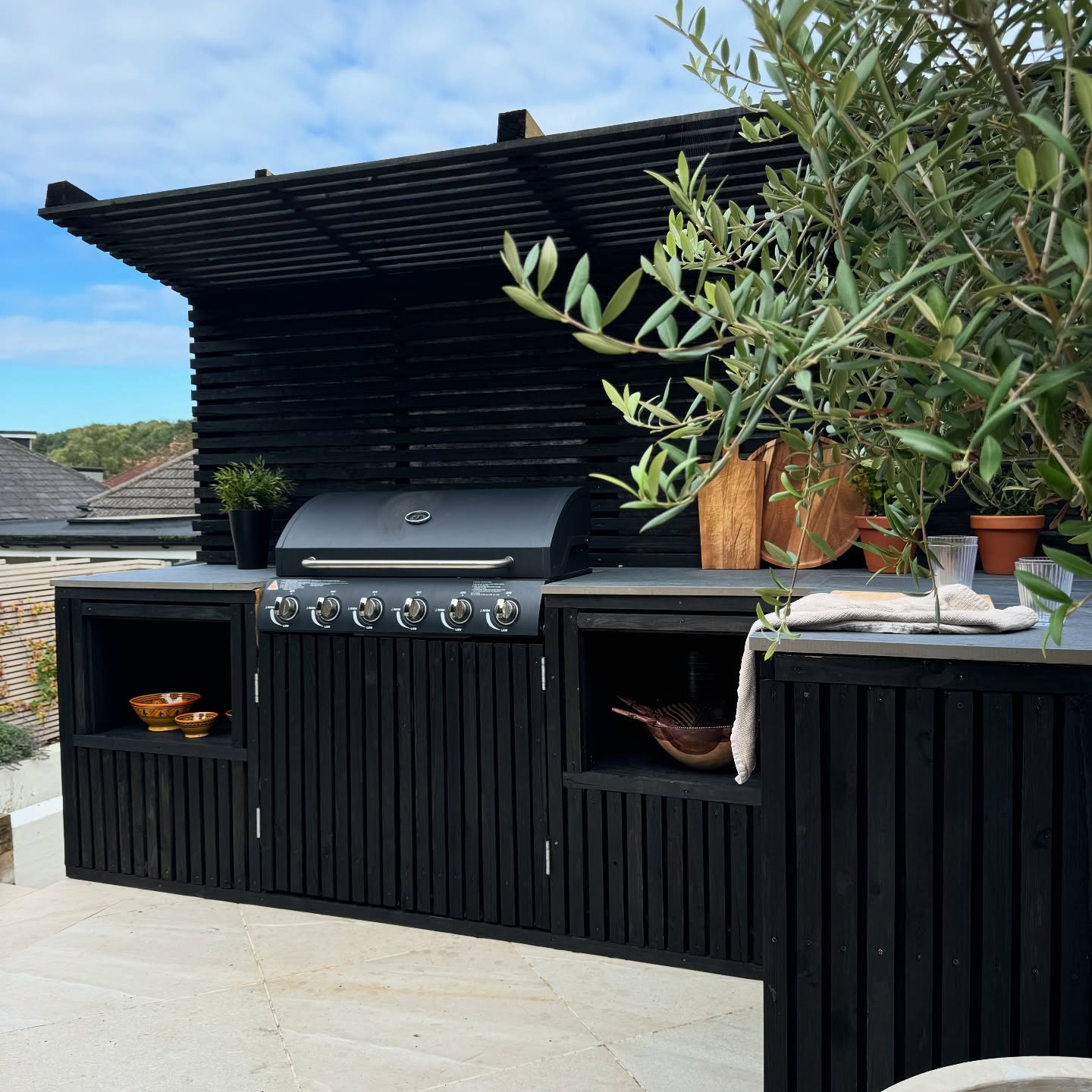 2. a Mosaic Of Memories: Cobblestone Countertops and Rustic Brick Oven In a Garden Nook