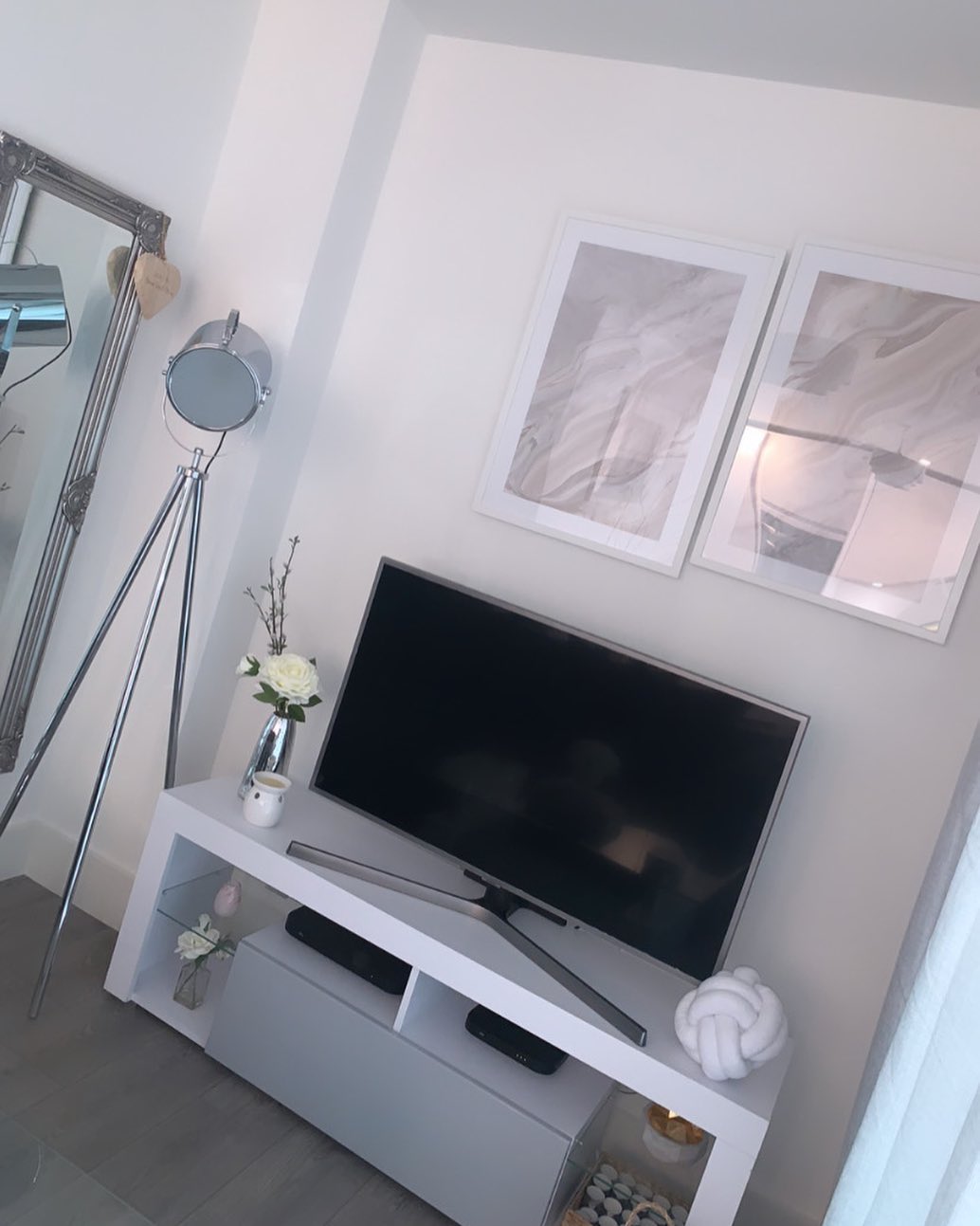 21. Whimsical Driftwood Mobile with Hanging Succulents and Fairy Lights Above a Minimalist Tv Console
