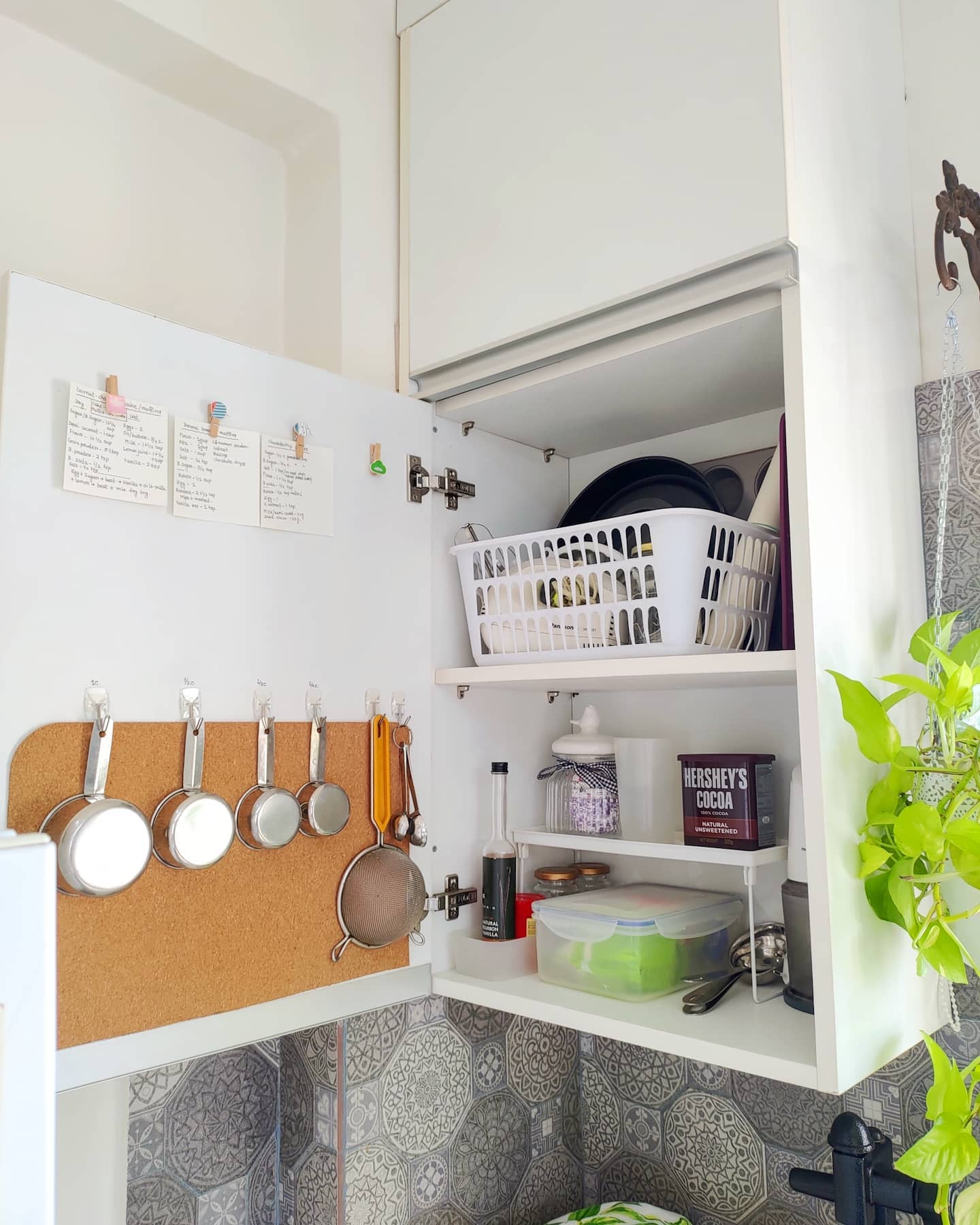 30. Sleek Pull-out Spice Rack with Geometric Wooden Handles In a Minimalist White Kitchen