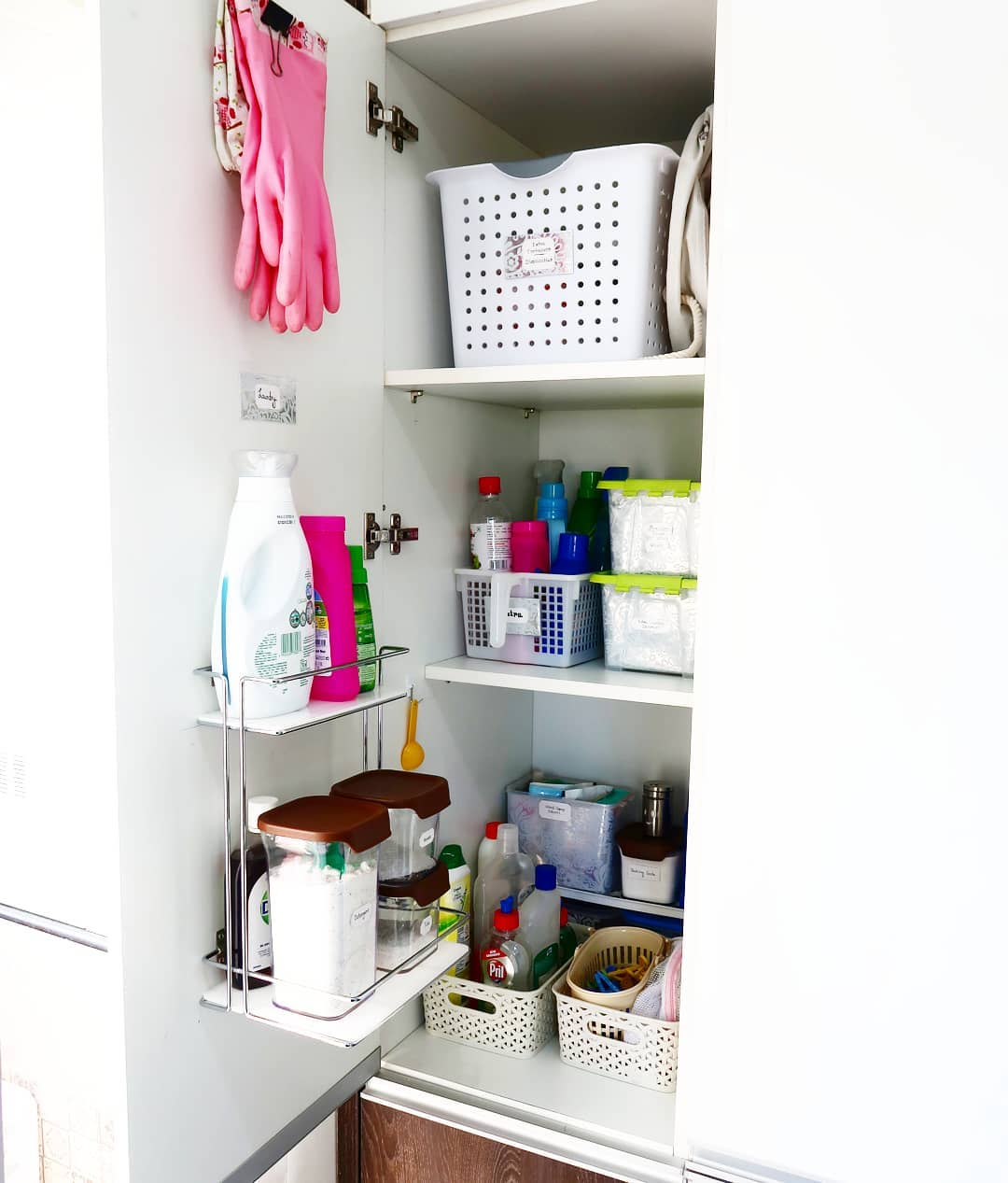 2. Glossy Black Pull-out Drawers with Sleek Spice Jars In a Minimalist Kitchen