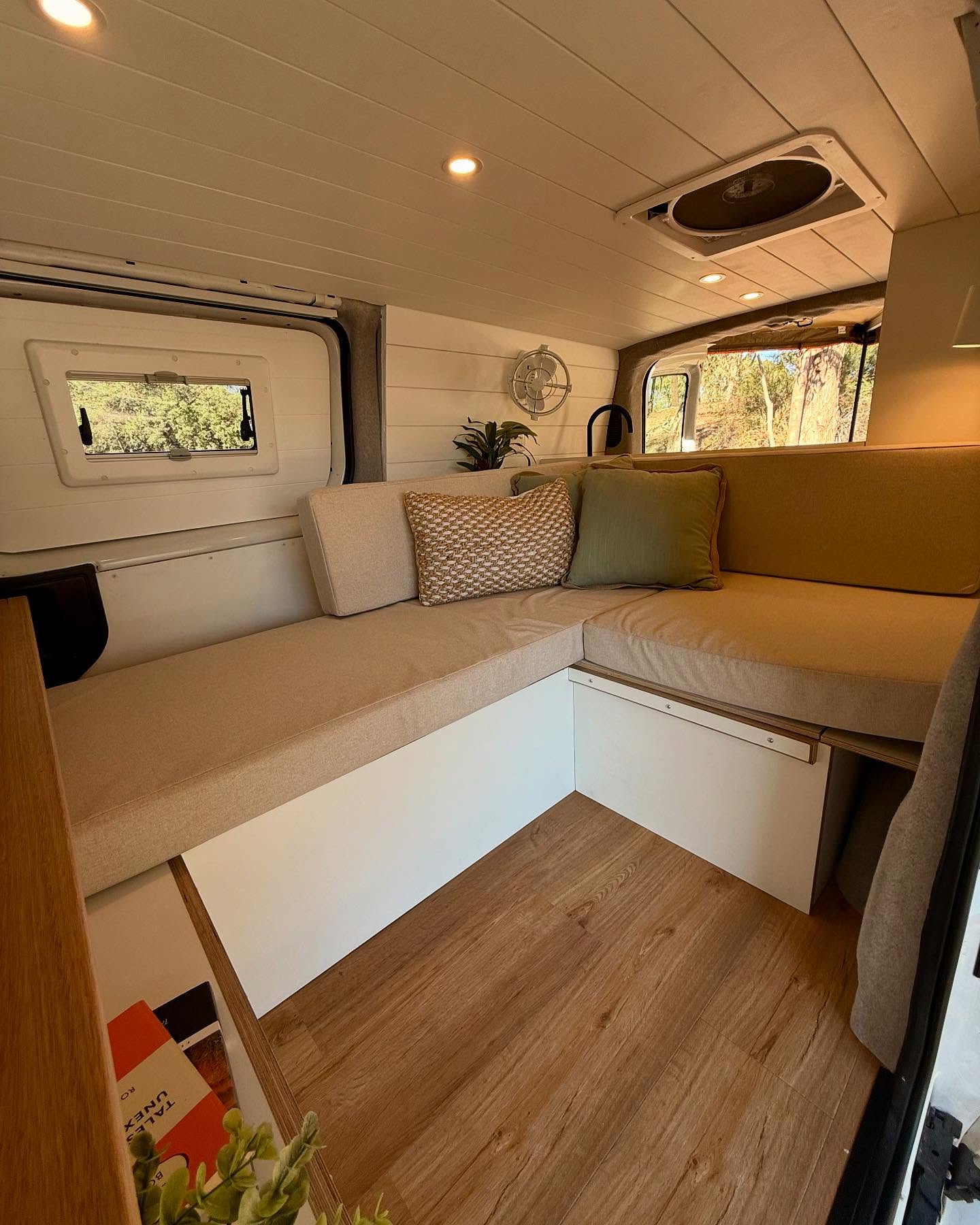 11. Cobalt Blue Cushions and Geometric Wood Paneling In a Cozy Camper Nook
