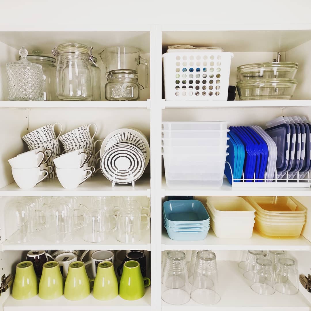 36. Sleek Pull-out Spice Racks with Geometric White Tiles In a Glossy Black Cabinet