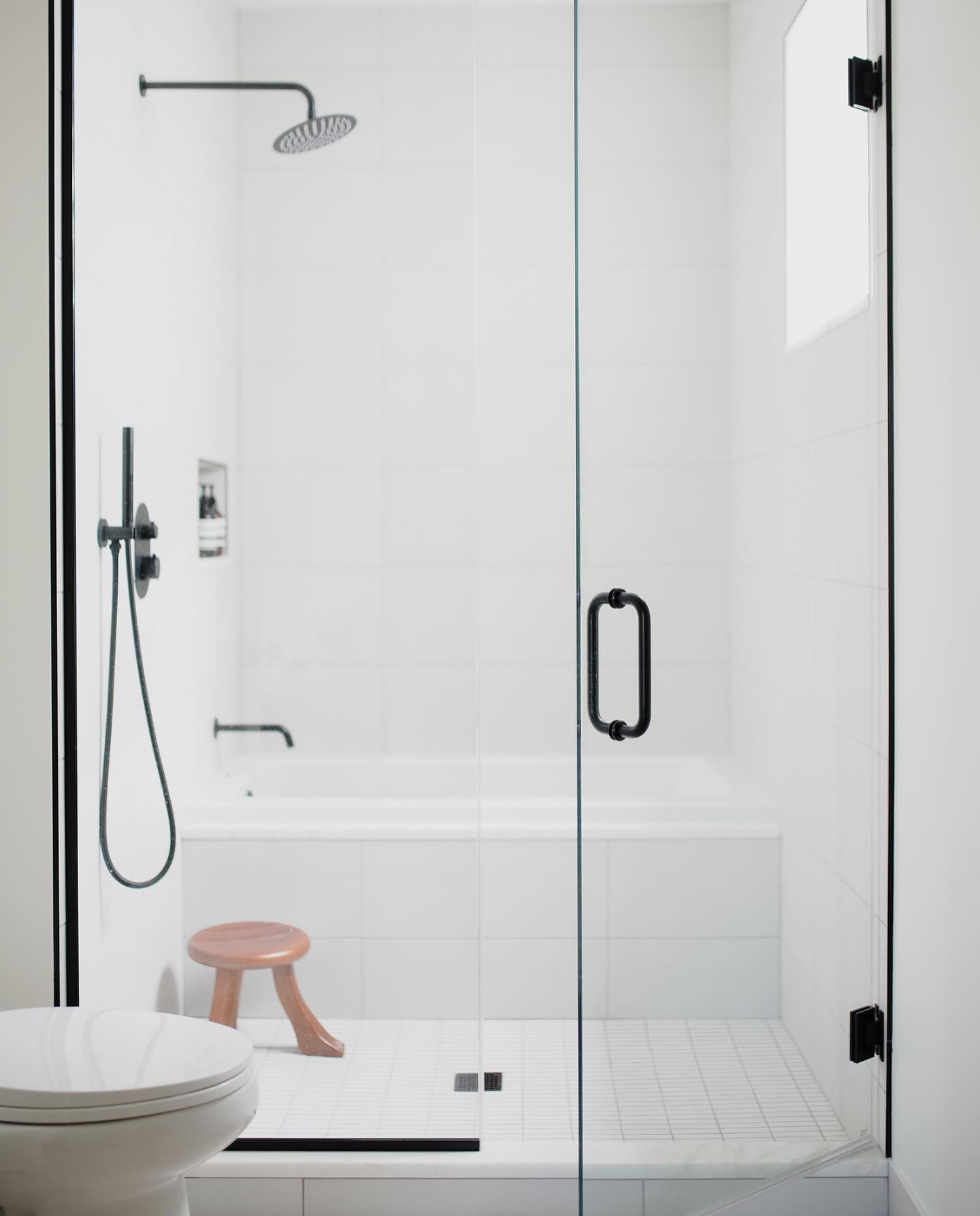 4. Metallic Mosaic Tiles and Wooden Shelf Fusion In a Compact Bathroom