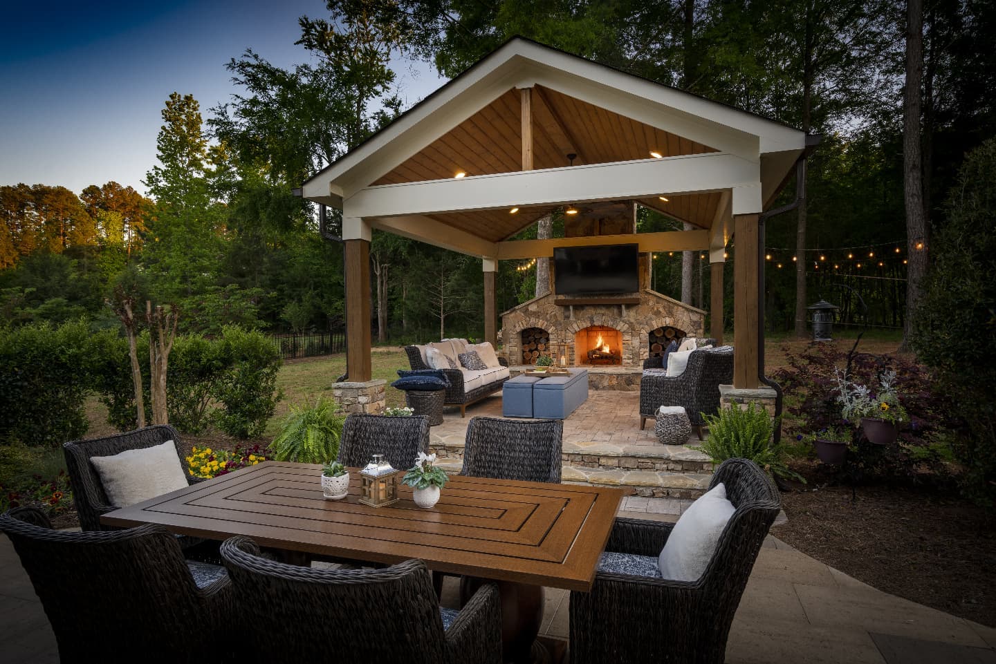 25. Twilight Bamboo Serenity: a Covered Patio with Hanging Lanterns and Lush Greenery