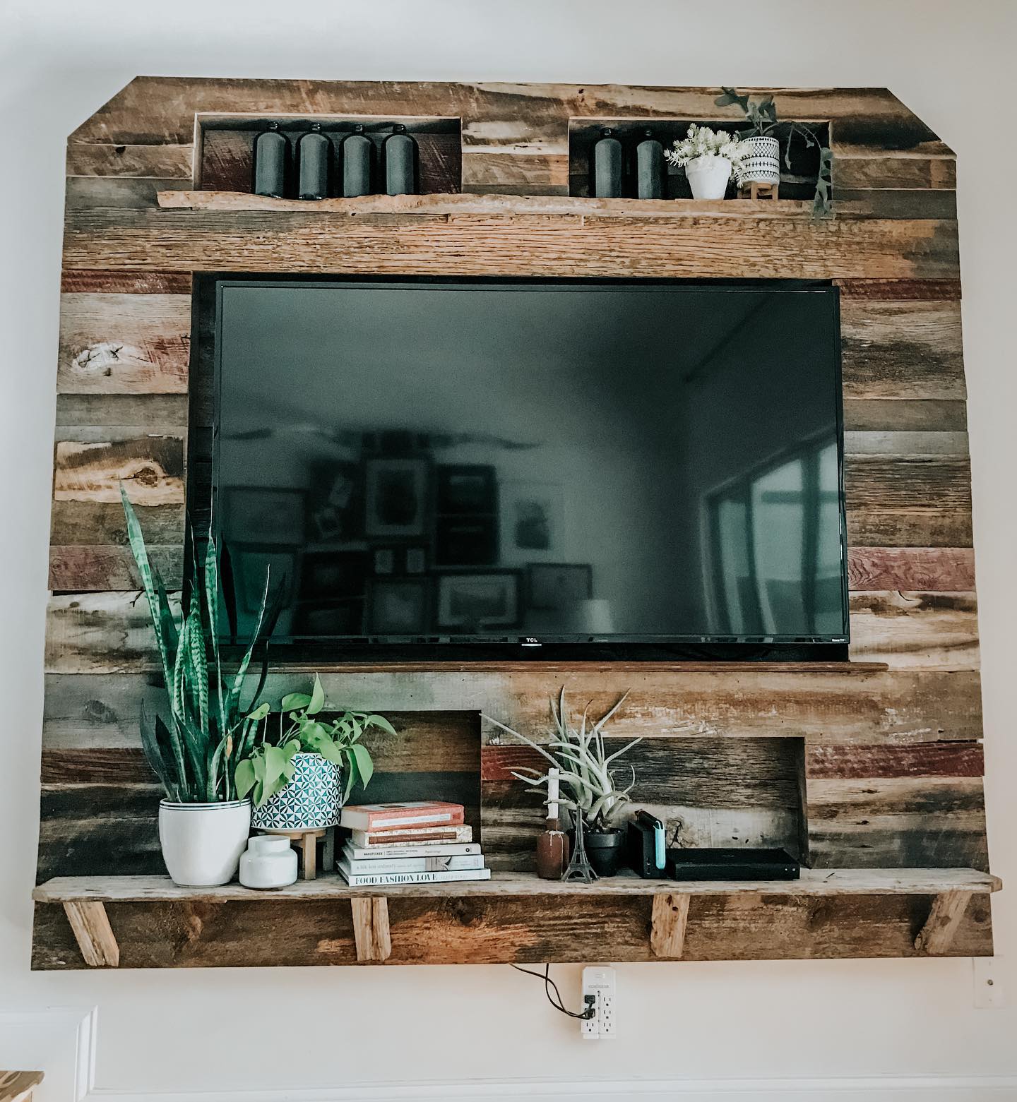 2. Bohemian Driftwood Mobile with Hanging Air Plants Above Sleek Black Tv Console