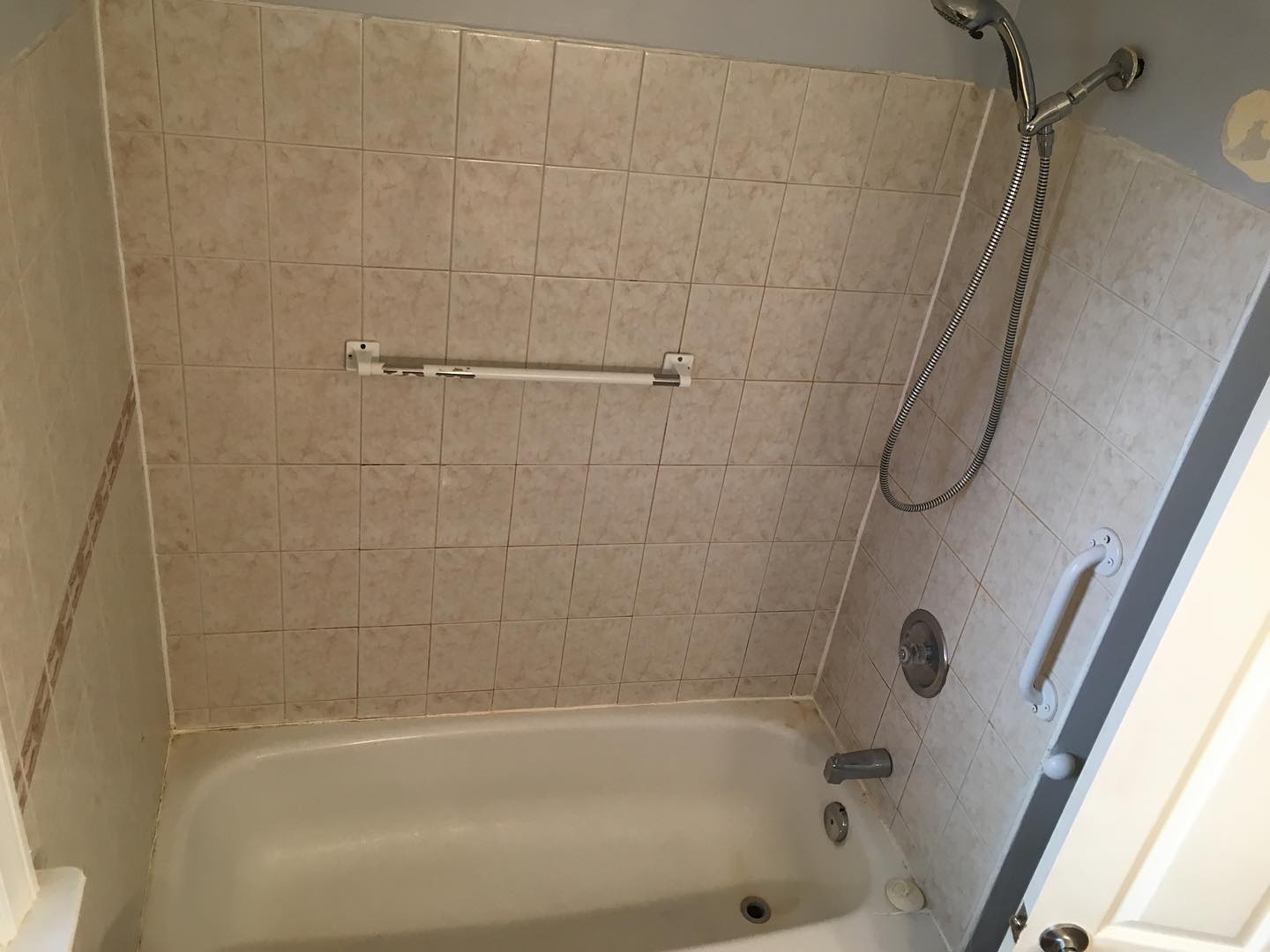 8. Metallic Mosaic Tiles and Geometric Niche Accent In a Sleek Tub and Shower Combo