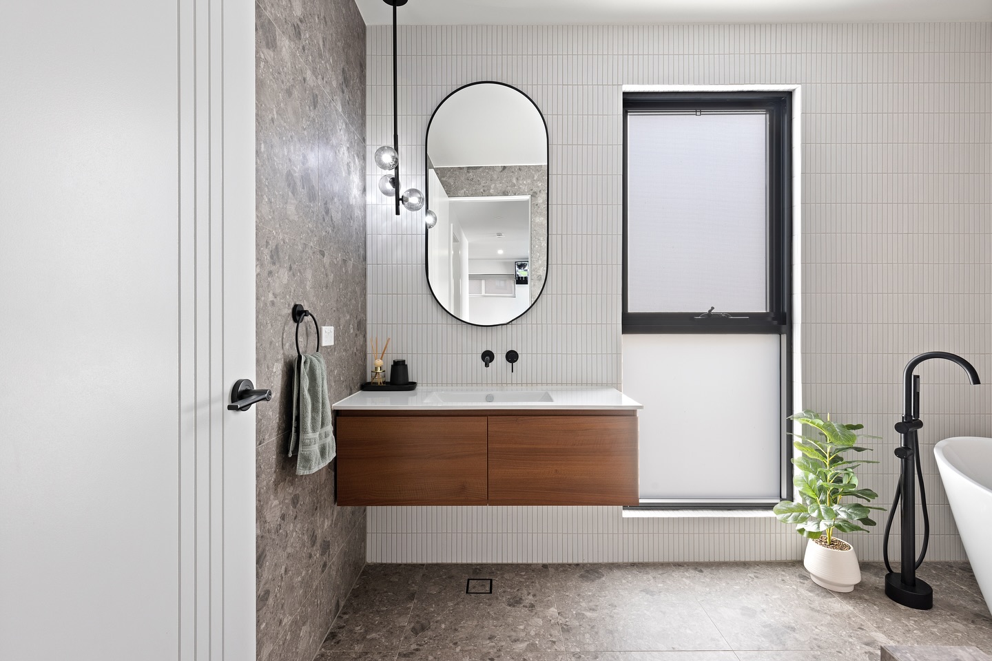 20. Radiant Ruby Tiles and Floating Vanity Fusion In a Compact Oasis