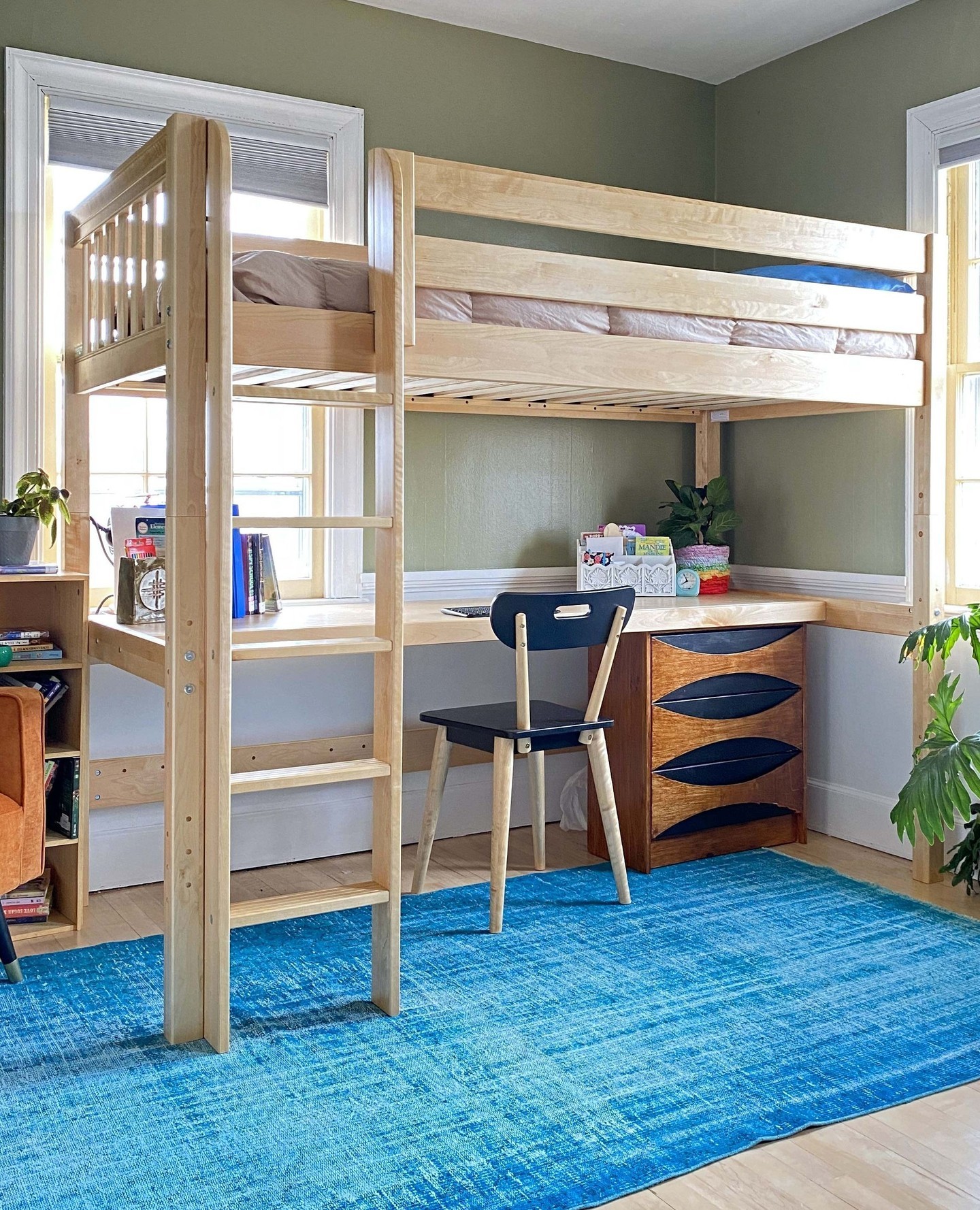 12. Loft Bed with Geometric Wall Art and Cozy Nook for a Teen's Creative Space