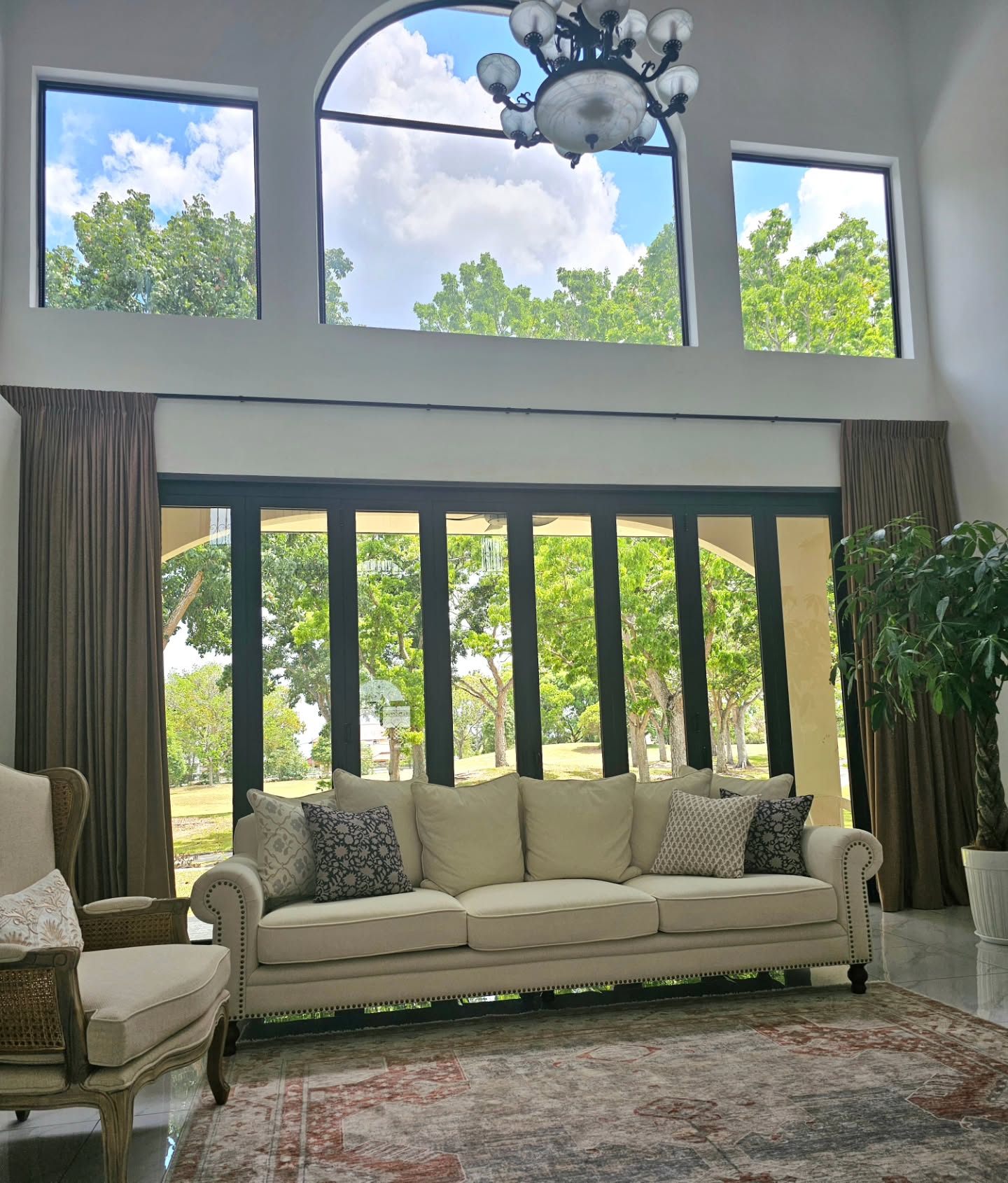 14. High Ceiling Haven with Geometric Brass Chandelier and Plush Velvet Seating