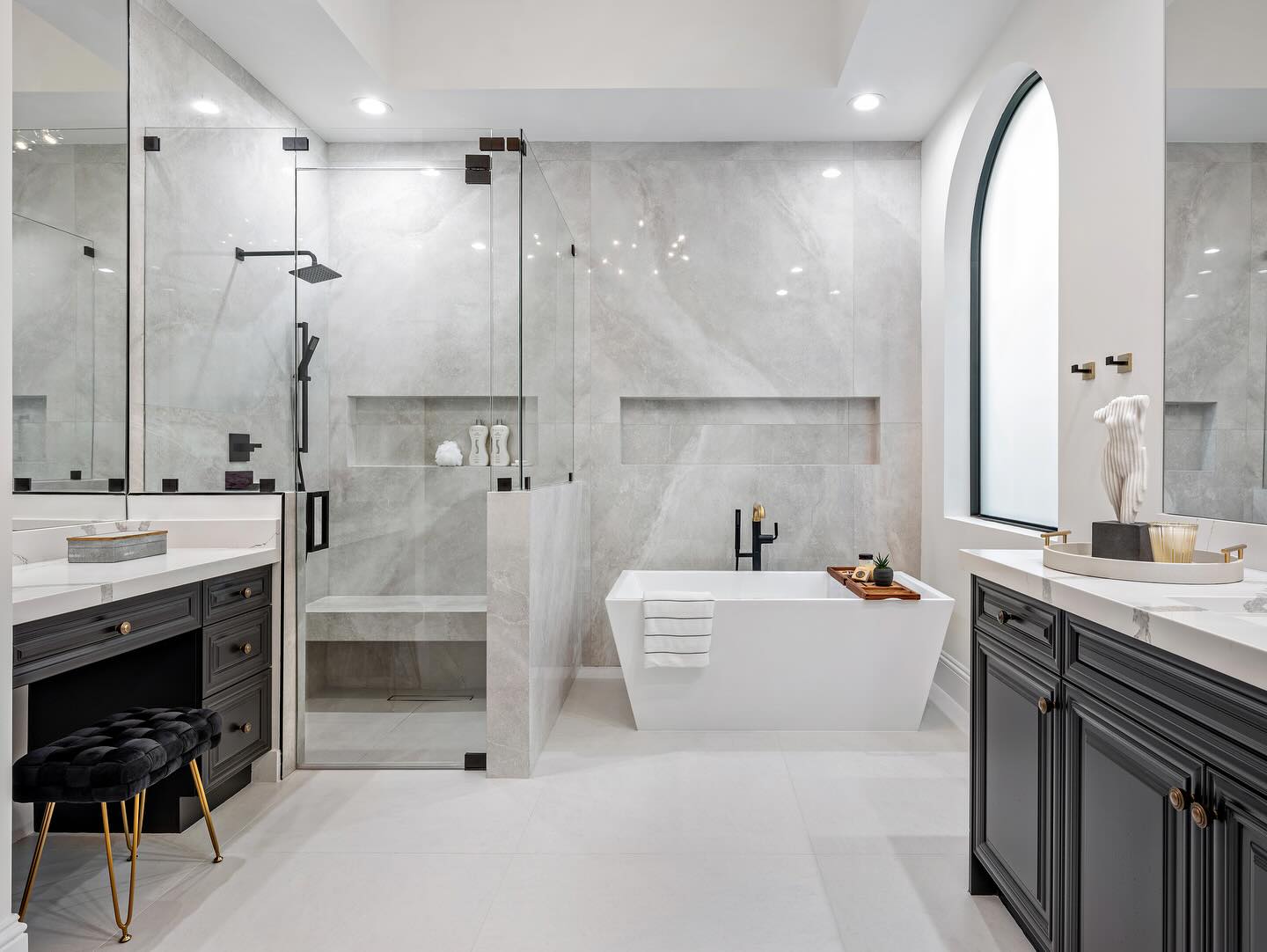 5. Sleek Black Sink with Geometric White Tiles and Circular Mirror Reflection