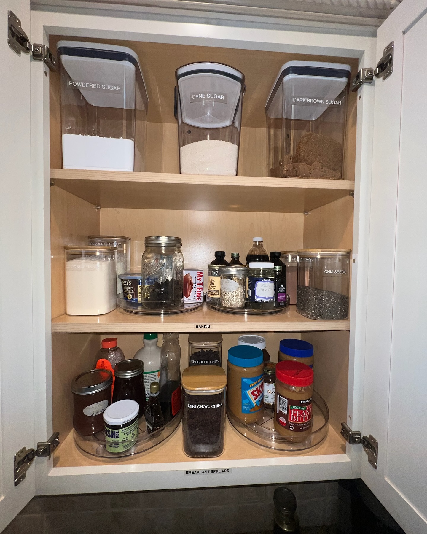5. Glossy White Cabinets with Interlocking Spice Jars and Hidden Lazy Susan