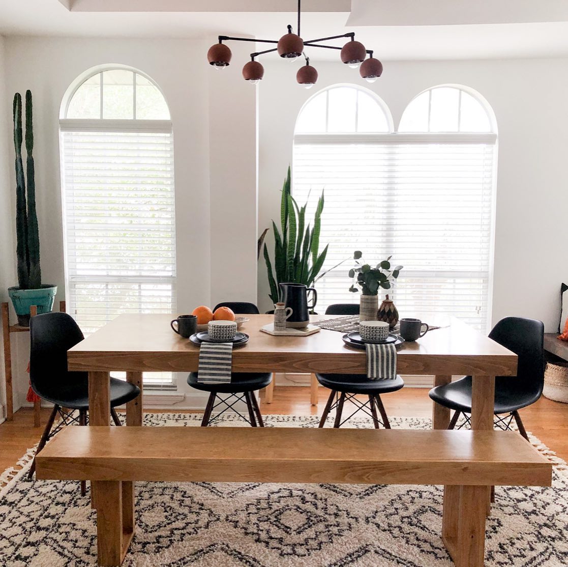 23. Vibrant Macrame Wall Hangings and Sunlit Distressed Wood Table