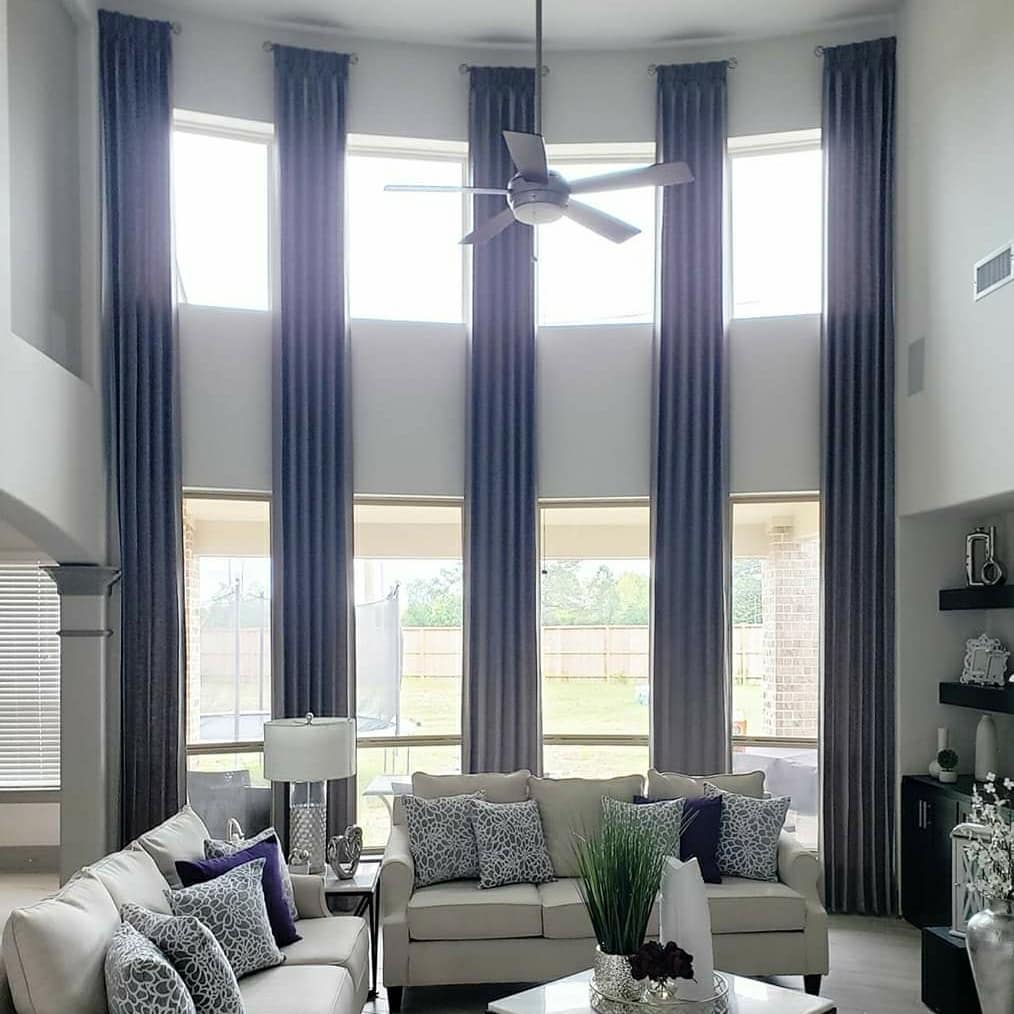 9. High Ceiling Haven with Exposed Beams and Geometric Wall Art