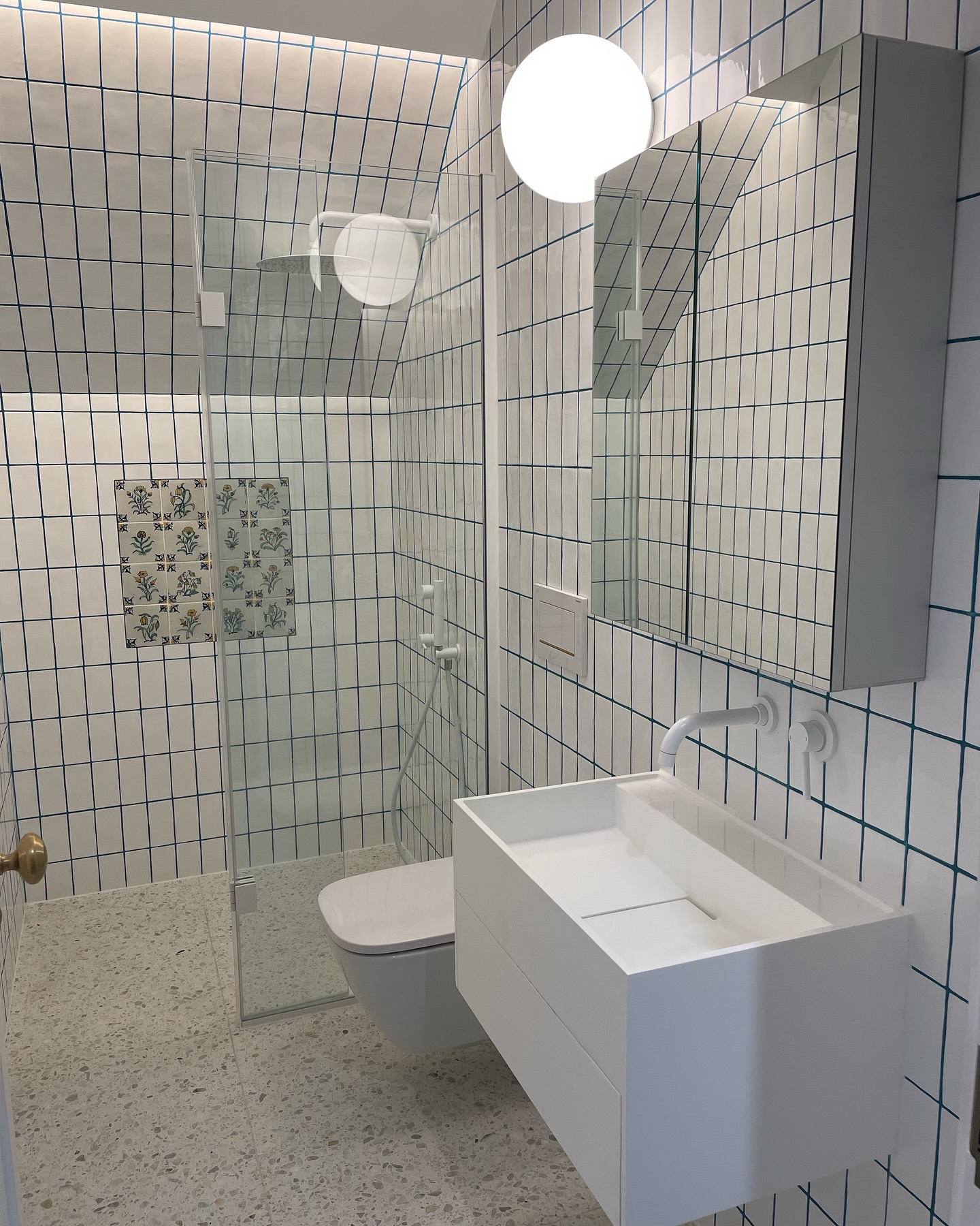 14. a Cascade Of Copper Pipes and Geometric White Tiles