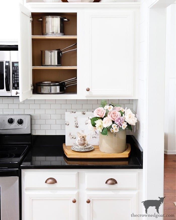 20. Sleek Pull-out Drawers with Geometric Spice Jars and a Hidden Toaster Oven Nook