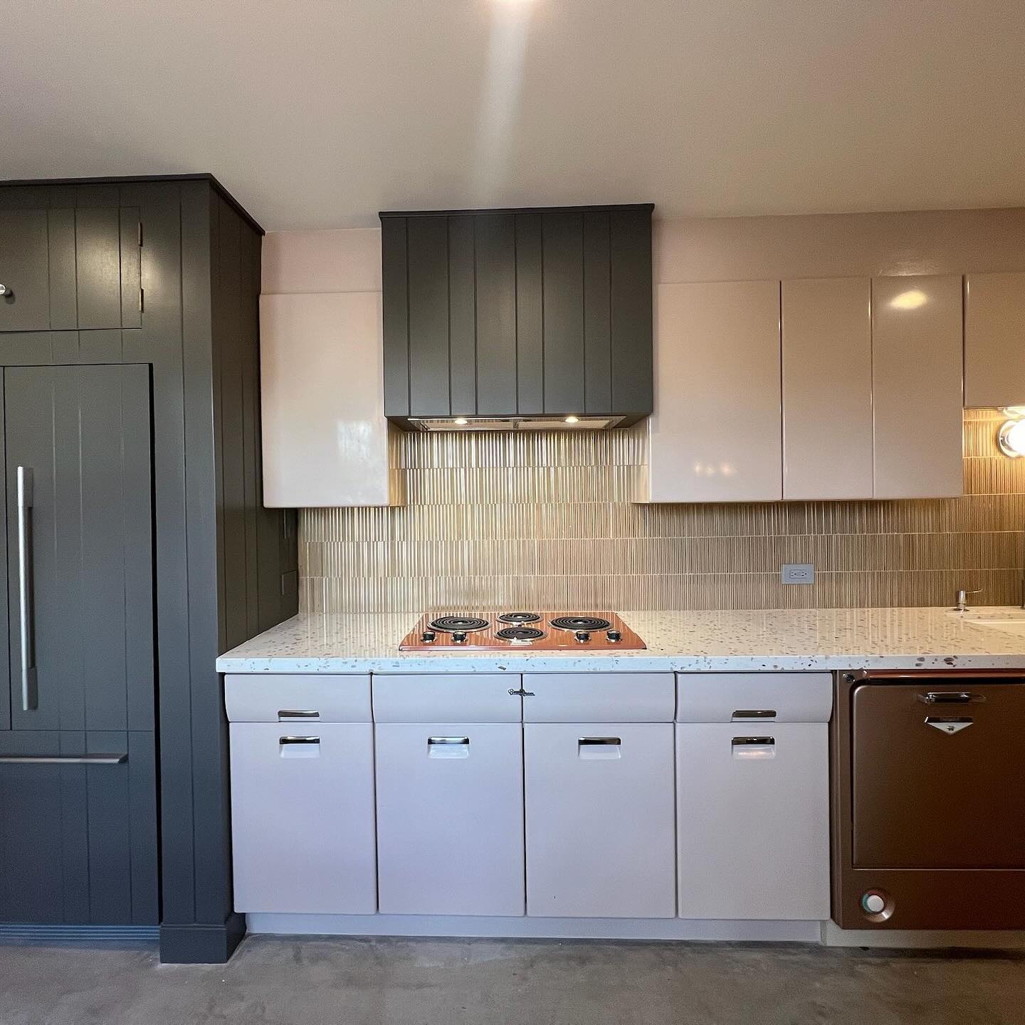 12. Vintage Brass Pendant Lights Illuminate a Retro Mint Green Refrigerator In a Mid Century Kitchen