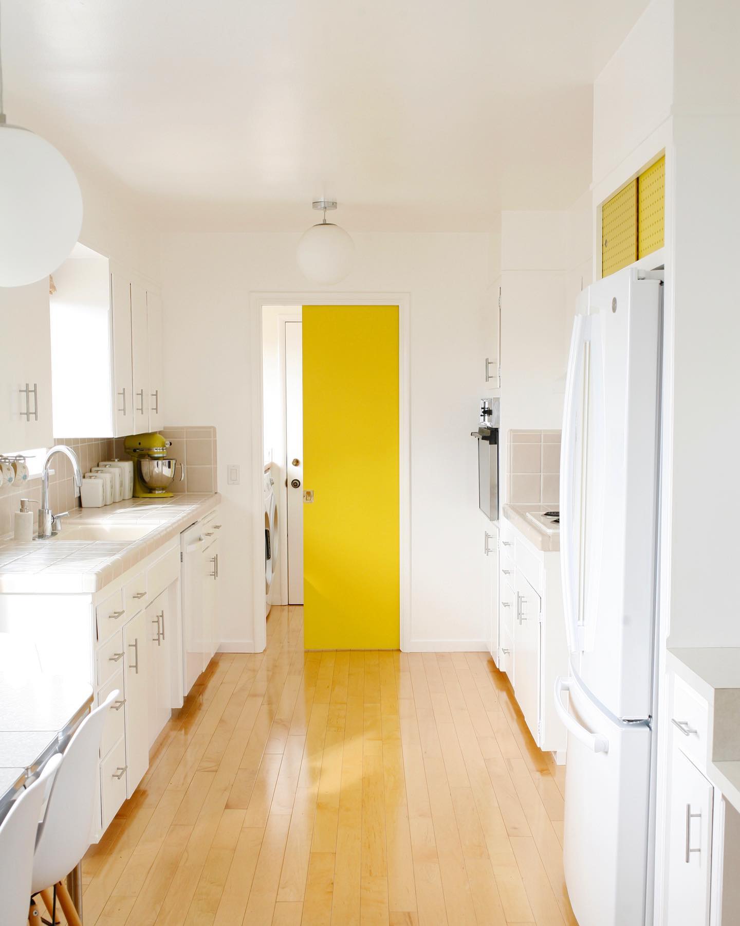 28. Vibrant Red Cabinets with Brass Hardware Against a Crisp White Subway Tile Backsplash