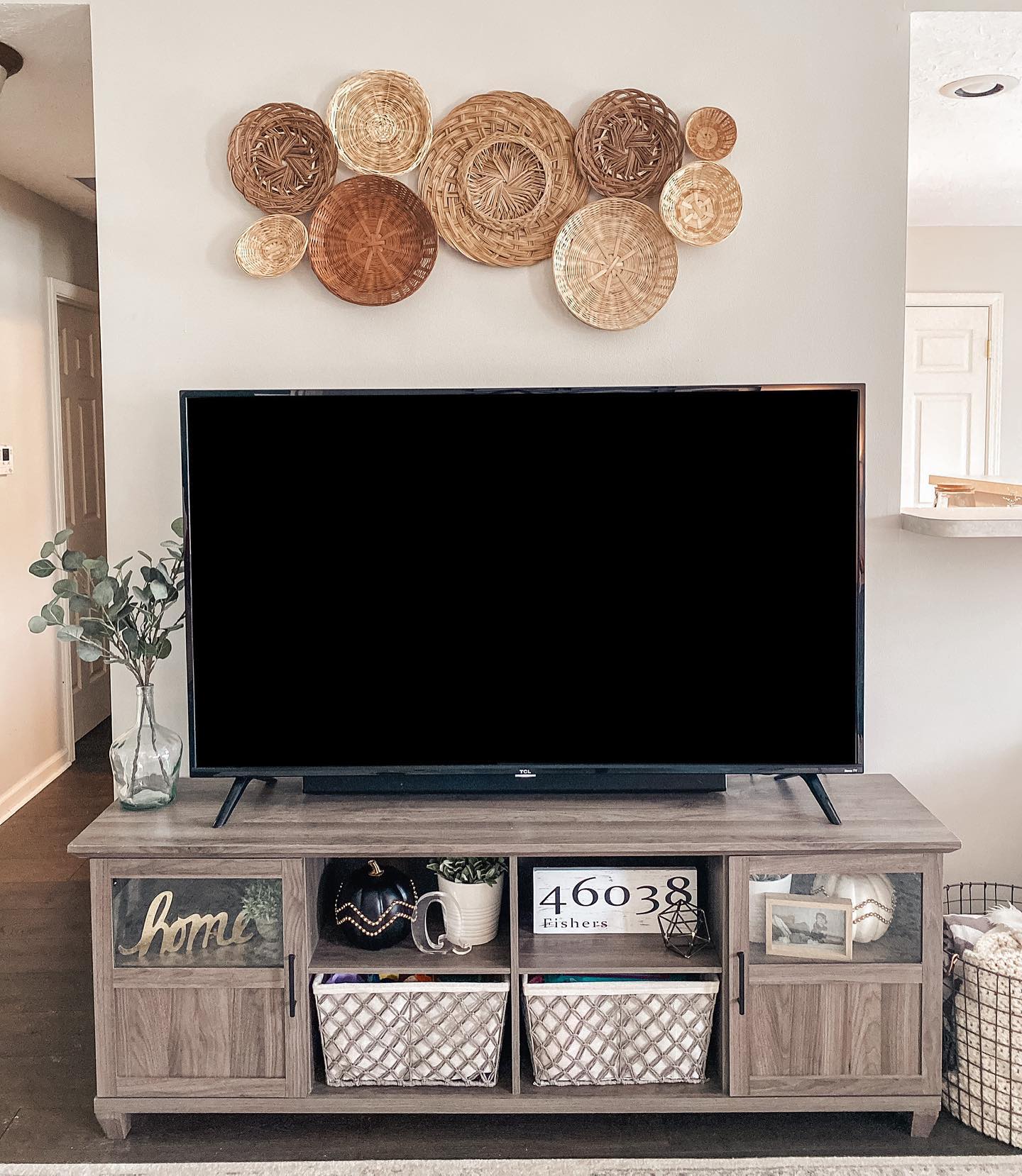 28. Floating Shelves and Geometric Art Above a Sleek Tv Setup