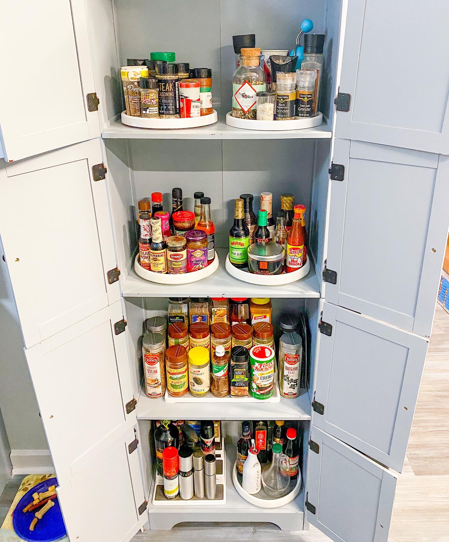 35. Floating Spice Rack with Glass Jars and Wooden Lids In a Minimalist White Kitchen