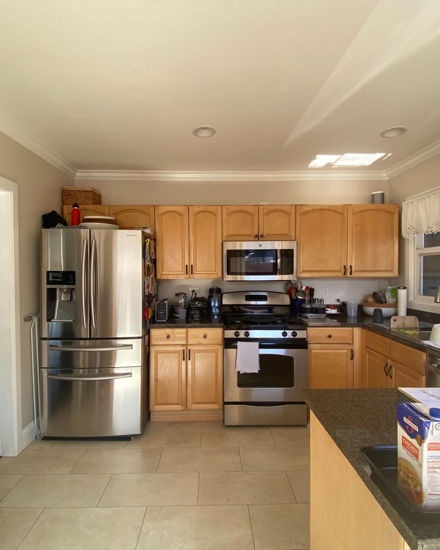 8. Sleek Black Cabinets with Copper Accents and a Retro Refrigerator