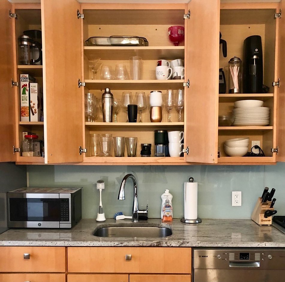 14. Sleek Pull-out Spice Racks with Geometric Patterned Backsplash