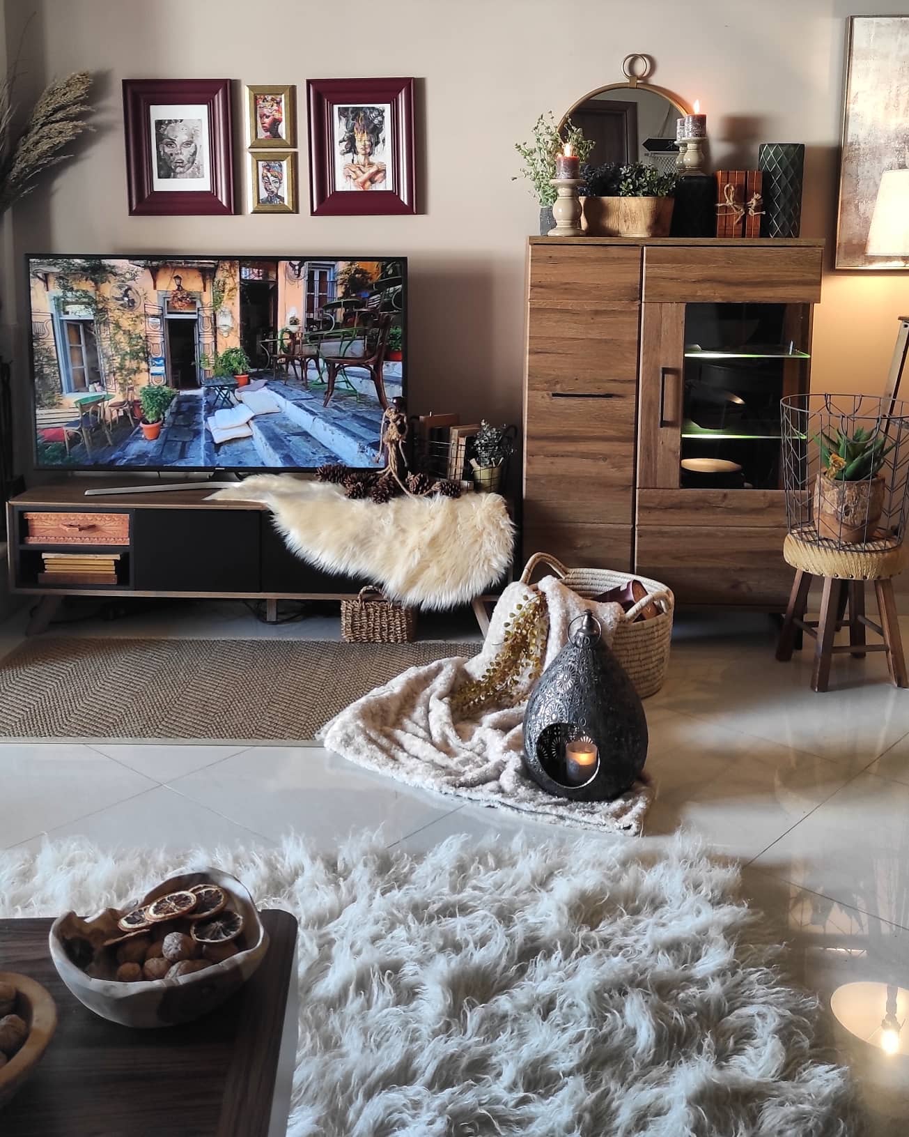 5. Vintage Clock and Botanical Art Fusion Above a Modern Tv