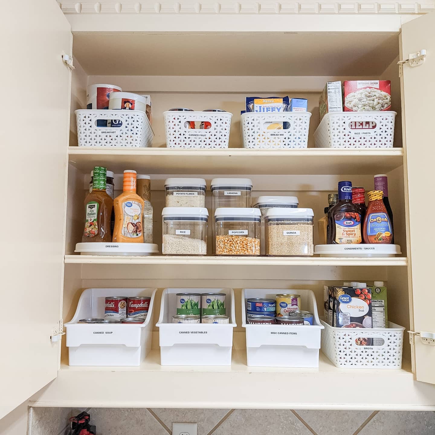 34. Sleek Pull-out Drawers with Matte Black Handles and Geometric Spice Jars