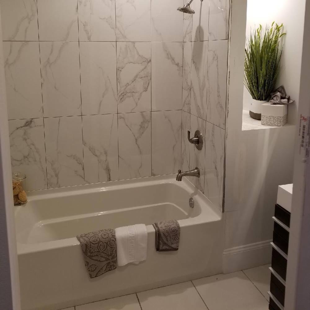 3. Moonlit Mosaic Tiles and Midnight Blue Accents In a Compact Tub-shower Fusion