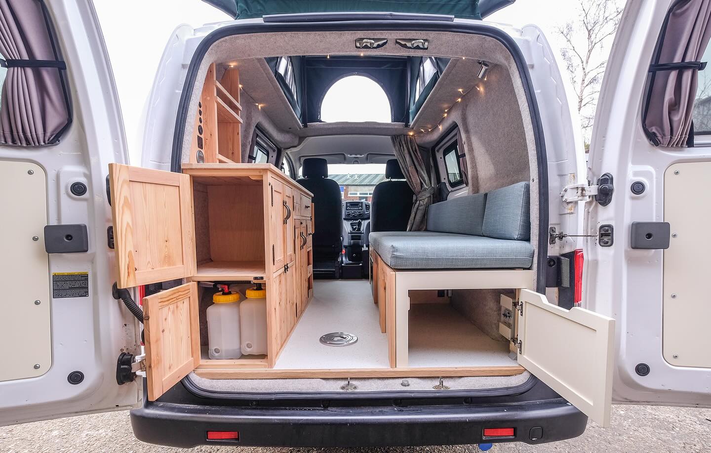 21. Tiny Camper Haven with Geometric Cushions and Vintage Map Wall