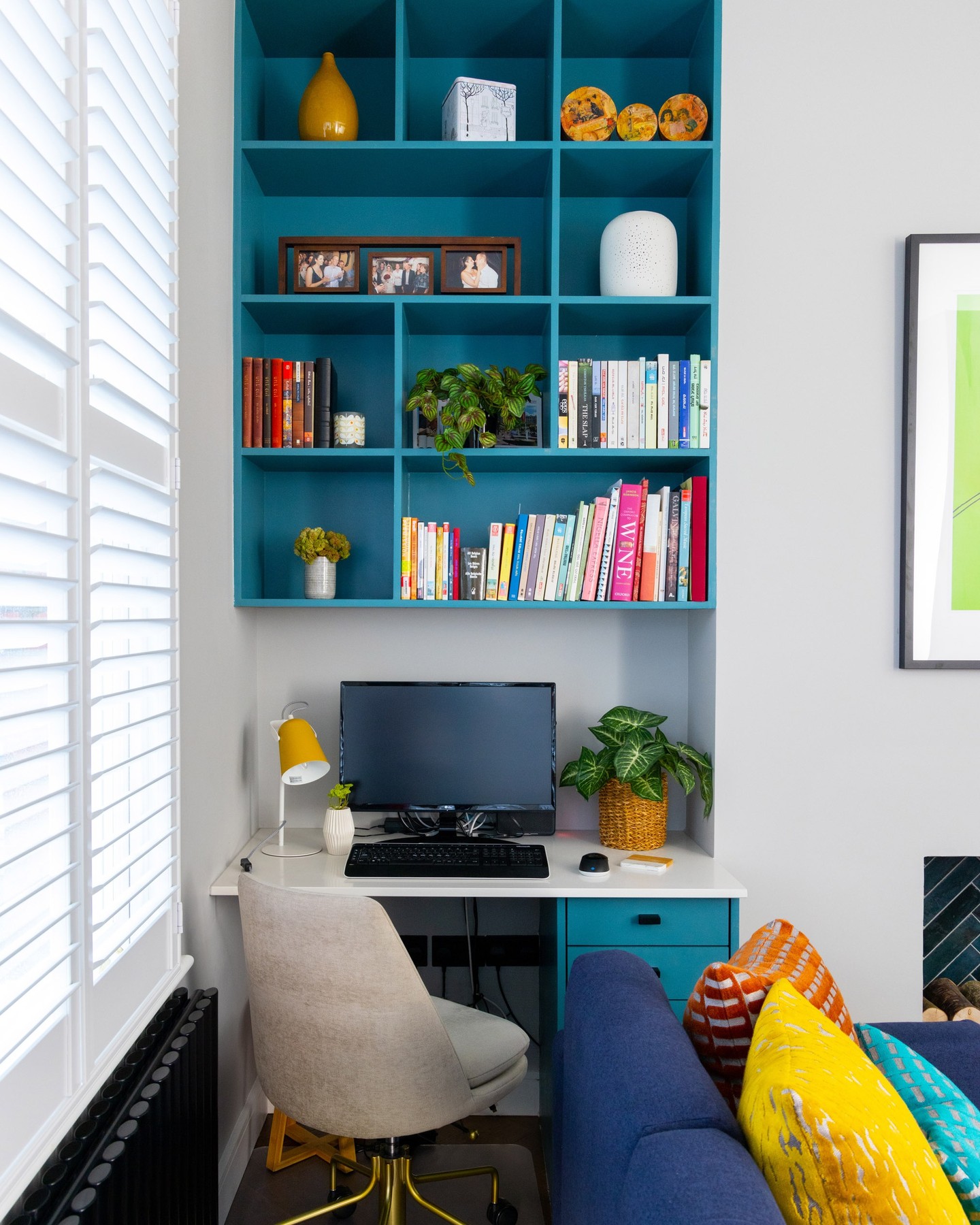 22. a Cactus-green Armchair Amidst Geometric Wall Shelves and a Sunlit Desk