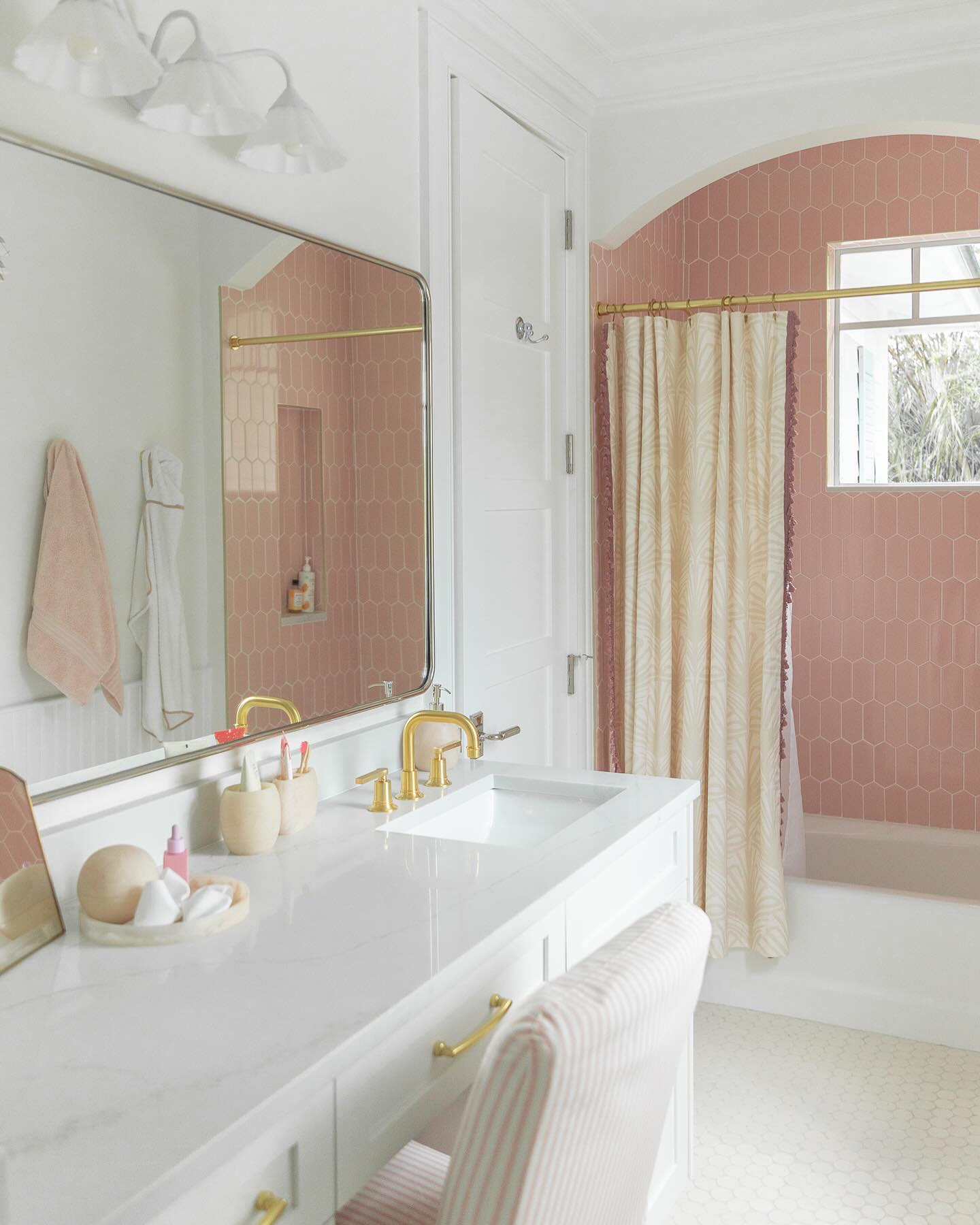 29. Vibrant Fuchsia Wall with Gold Accents Reflecting In Mirror