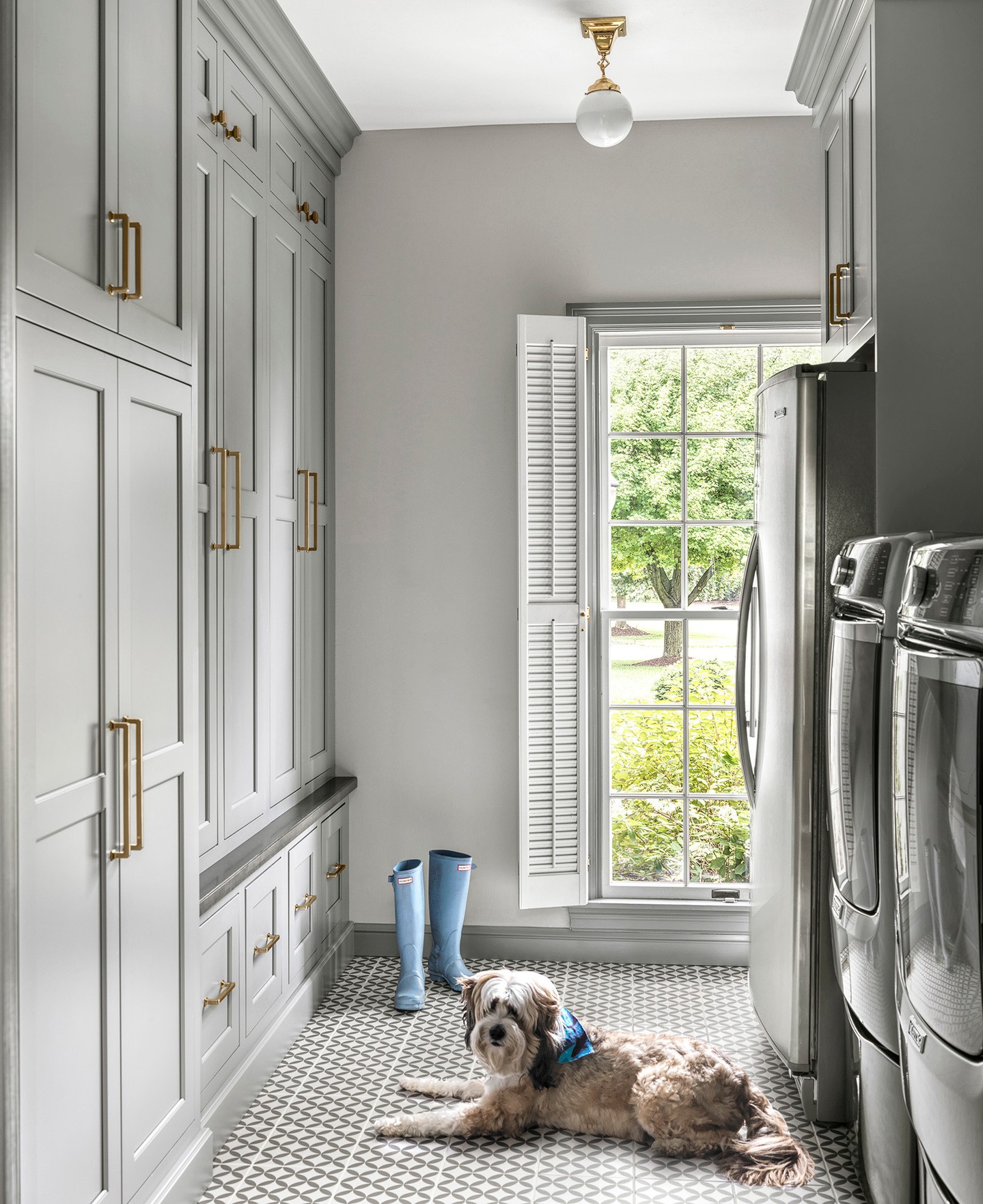 8. Vibrant Turquoise Cabinets with Copper Handles and Built-in Ironing Board