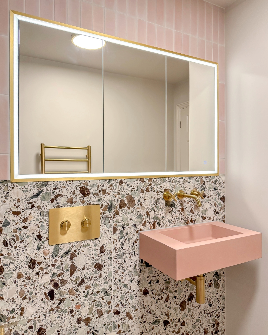 16. Moonlit Marble and Metallic Magic: the Bathroom Cabinet with a Celestial Glow