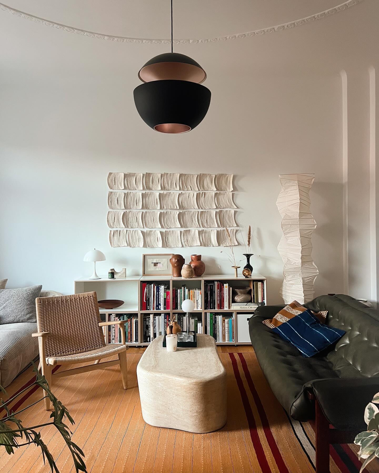 11. Bookshelf with a Spiraling Vine Of Books and a Neon Green Accent Light